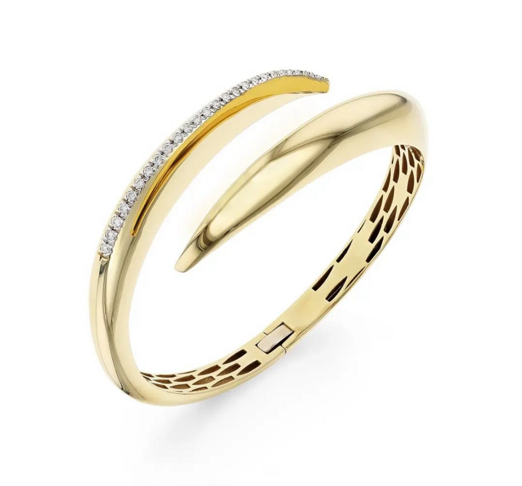 Elevate your accessory game with our 14k Italian Yellow Gold Diamond Bangle Bracelet. Crafted in Italy, this piece showcases a hinged system for easy wear and dazzling round diamonds 0.31 cts in an H/SI1 quality. Make a statement with our Veneroso Collection.