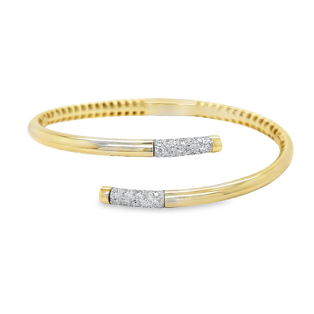 Elevate your accessory game with our 14k Italian Yellow Gold Diamond Bangle Bracelet. Crafted in Italy, this piece showcases a hinged system for easy wear and dazzling round diamonds cts in an H/SI1 quality. Make a statement with our Veneroso Collection.