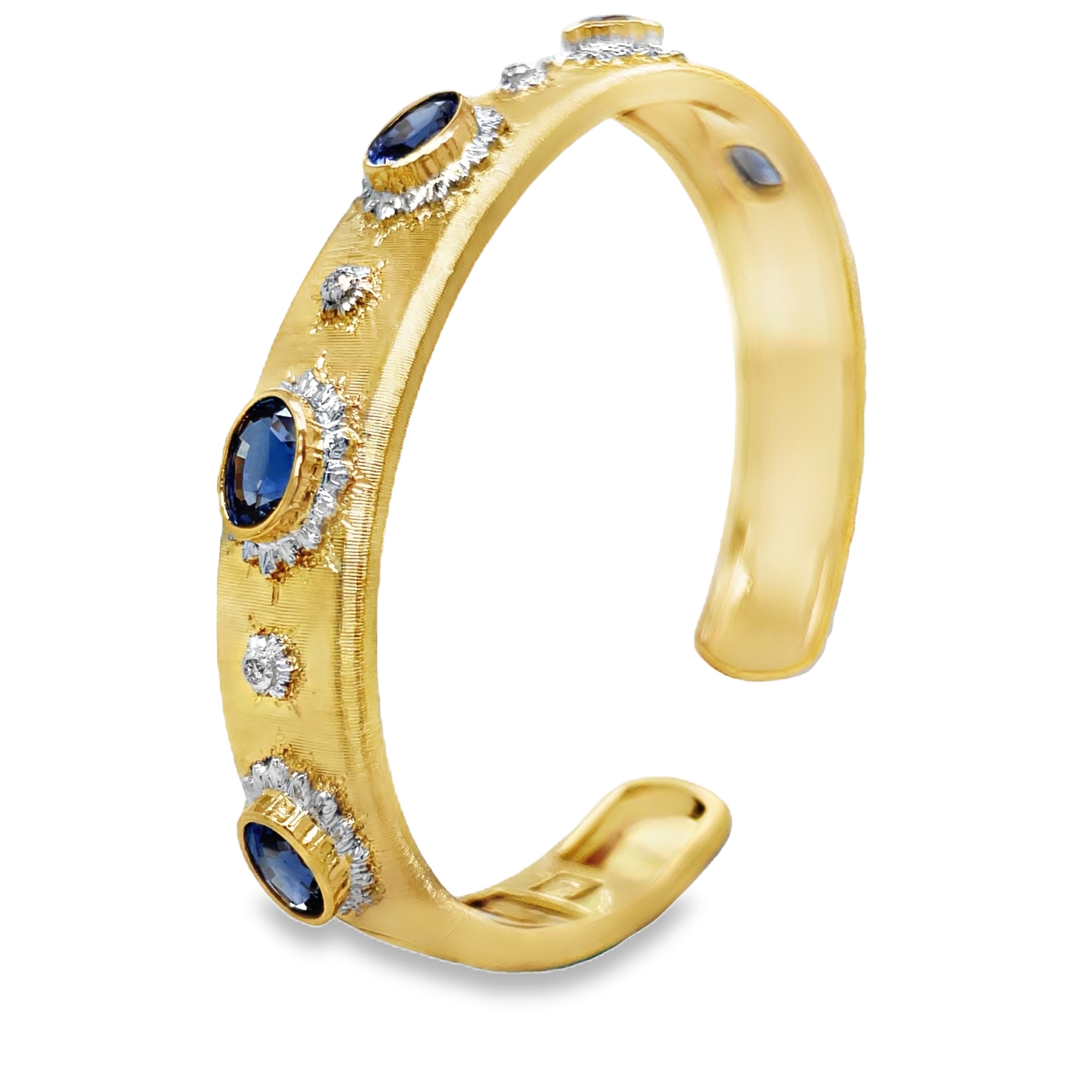 Elevate your style with our Italian 18K Yellow Gold Bangle Bracelet. Handcrafted with 18K gold, this exquisite piece features five oval sapphires and round diamonds for a total of 3.98 cts. The brushed finish adds a touch of elegance and sophistication. Indulge in luxury and make a statement with this Italian-made bracelet.