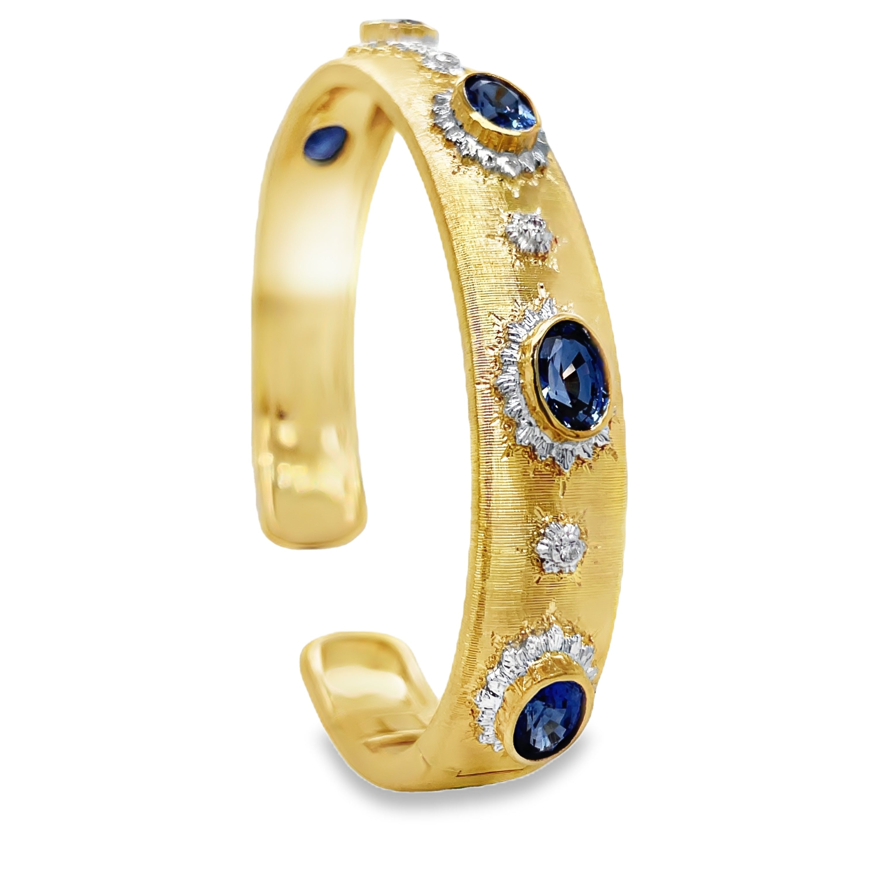 Elevate your style with our Italian 18K Yellow Gold Bangle Bracelet. Handcrafted with 18K gold, this exquisite piece features five oval sapphires and round diamonds for a total of 3.98 cts. The brushed finish adds a touch of elegance and sophistication. Indulge in luxury and make a statement with this Italian-made bracelet.