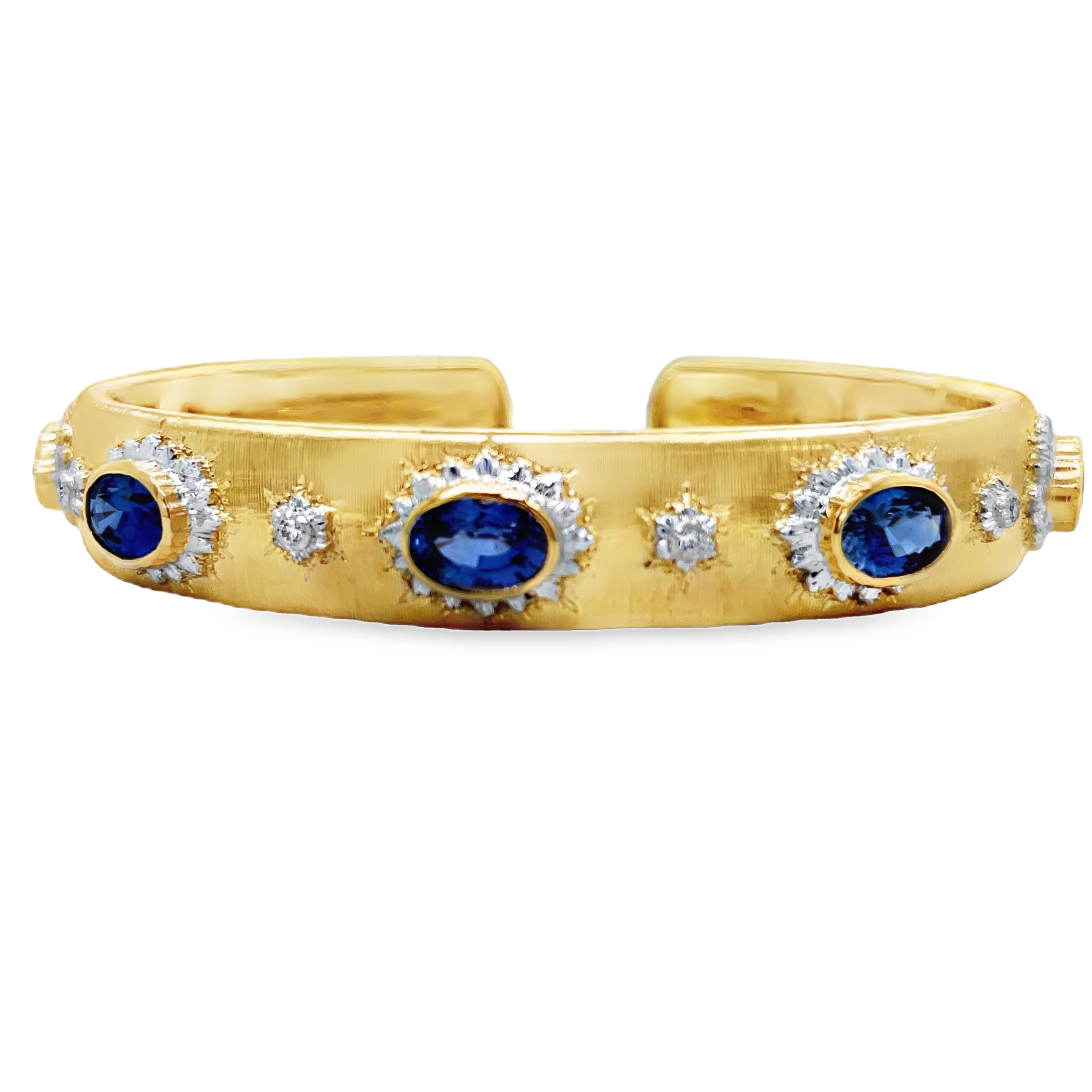 Elevate your style with our Italian 18K Yellow Gold Bangle Bracelet. Handcrafted with 18K gold, this exquisite piece features five oval sapphires and round diamonds for a total of 3.98 cts. The brushed finish adds a touch of elegance and sophistication. Indulge in luxury and make a statement with this Italian-made bracelet.