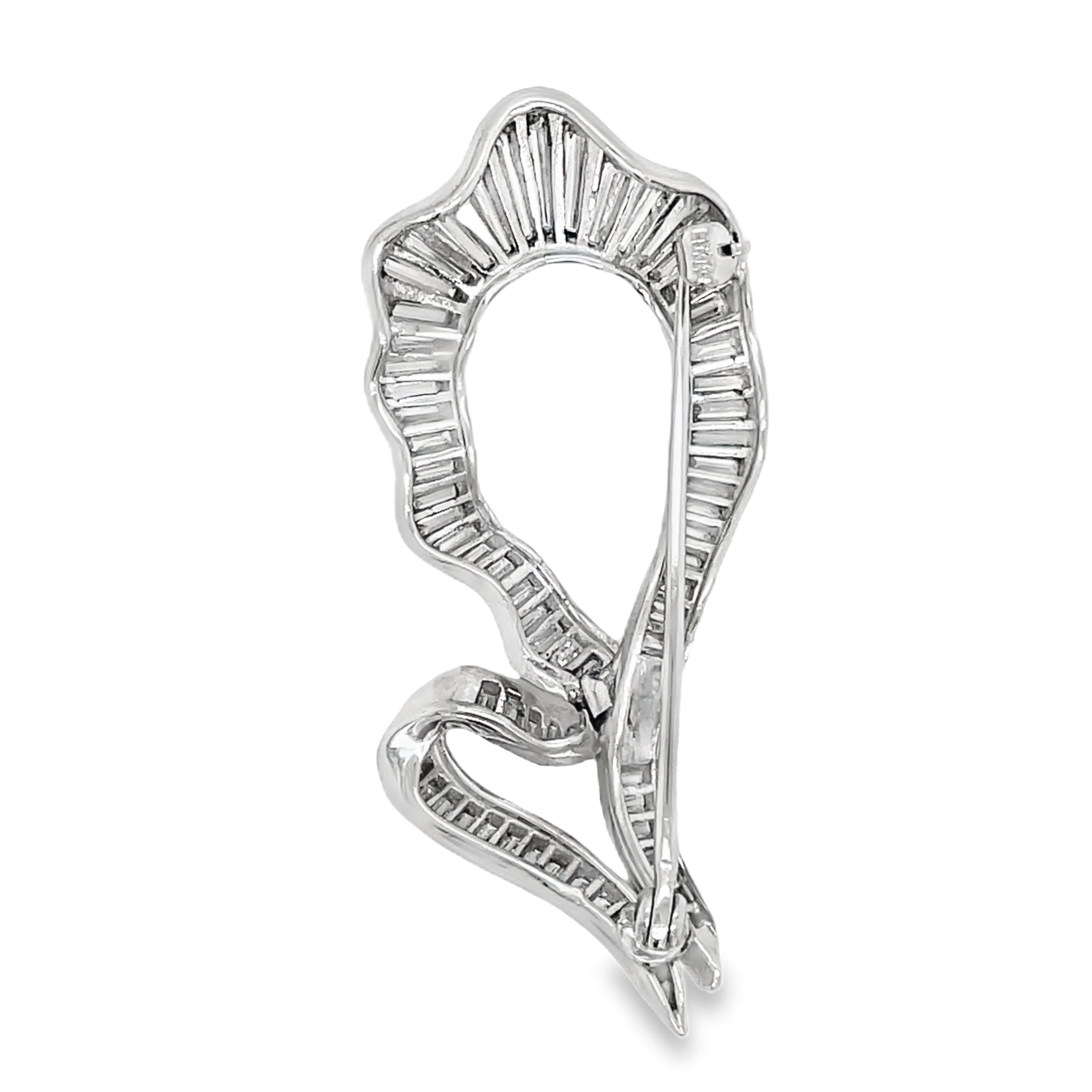 Elevate your style with this Antique Baguette Diamond Brooch. Crafted with 14k white gold and adorned with 1.75 carats of sparkling baguette diamonds, this brooch exudes timeless elegance. Part of our exclusive estate collection, it is a true statement piece for any sophisticated wardrobe.