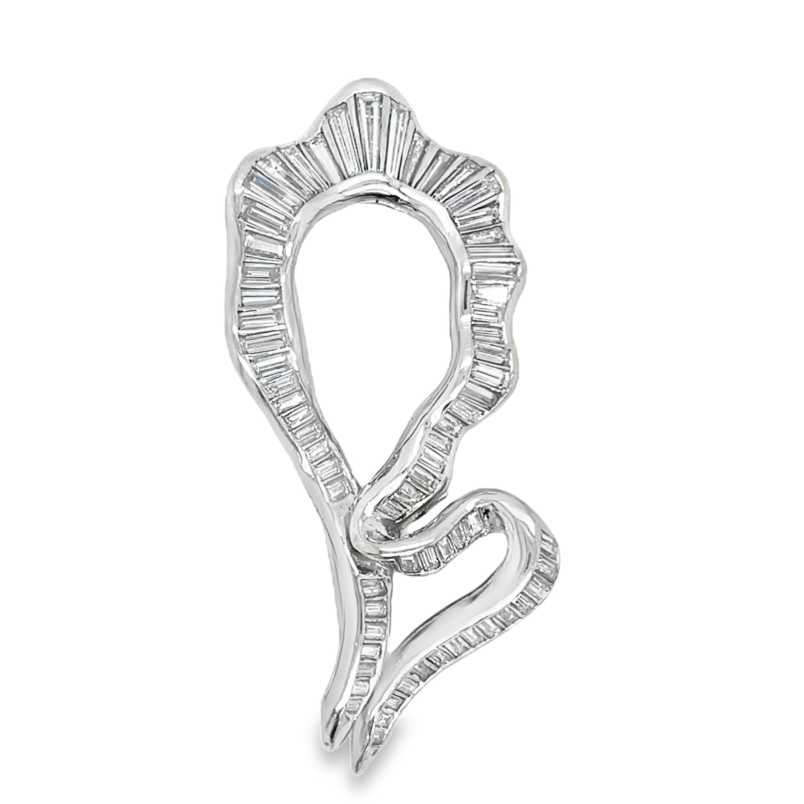 Elevate your style with this Antique Baguette Diamond Brooch. Crafted with 14k white gold and adorned with 1.75 carats of sparkling baguette diamonds, this brooch exudes timeless elegance. Part of our exclusive estate collection, it is a true statement piece for any sophisticated wardrobe.