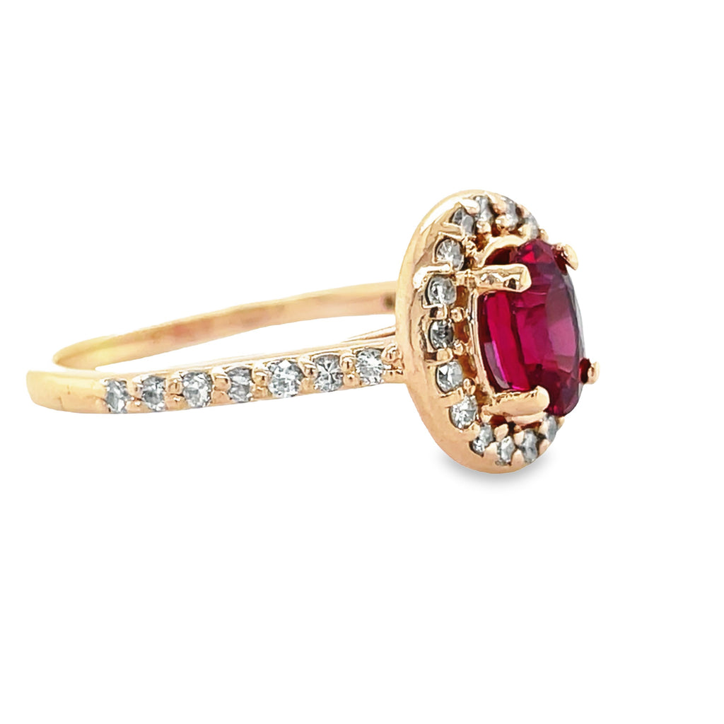 This 14k rose gold ring showcases an oval-shaped ruby of 1.20 carats, encircled by 20 brilliant round diamonds of 0.20 carats. Its exquisite design will add a timelessly classy touch to any look.