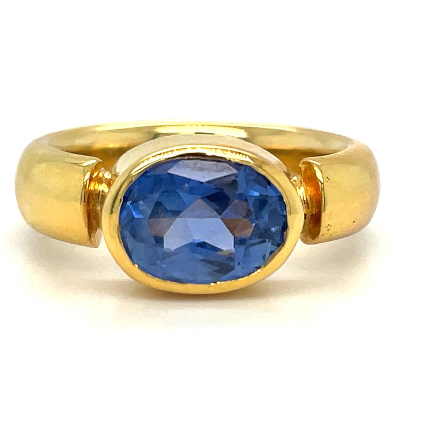 Custom made Oval Cut Sapphire Horizontal Gold Bezel Ring Front view 