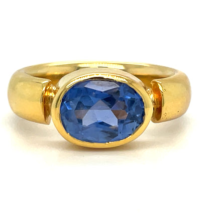 A modern take on the classic cocktail ring, this custom design showcases a 3.10 ct Oval Cut sapphire set east-west in a contemporary 18k gold bezel setting. Set in a comfortable fit band ensures all-day comfort.