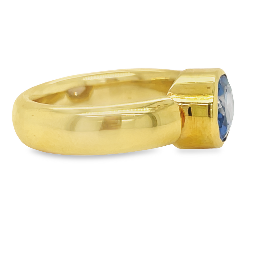 A modern take on the classic cocktail ring, this custom design showcases a 3.10 ct Oval Cut sapphire set east-west in a contemporary 18k gold bezel setting. Set in a comfortable fit band ensures all-day comfort.