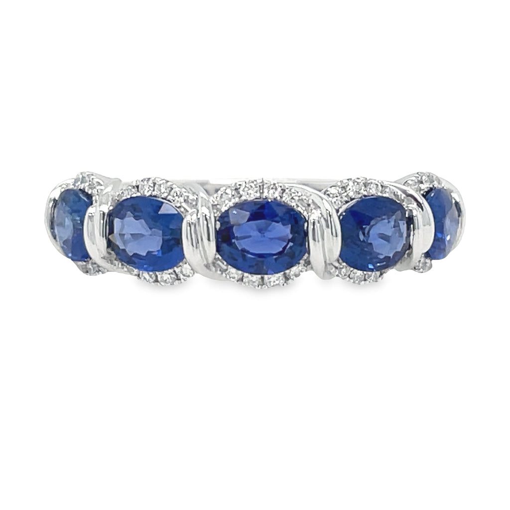Celebrate your special day in style with this exquisite Oval Blue Sapphire & Diamond Anniversary Ring, beautifully crafted in 14k white gold and adorned with 2.18 cts of exquisite oval-shaped blue sapphires and 0.19 cts of sparkling round diamonds. Create a special memory that will last a lifetime.