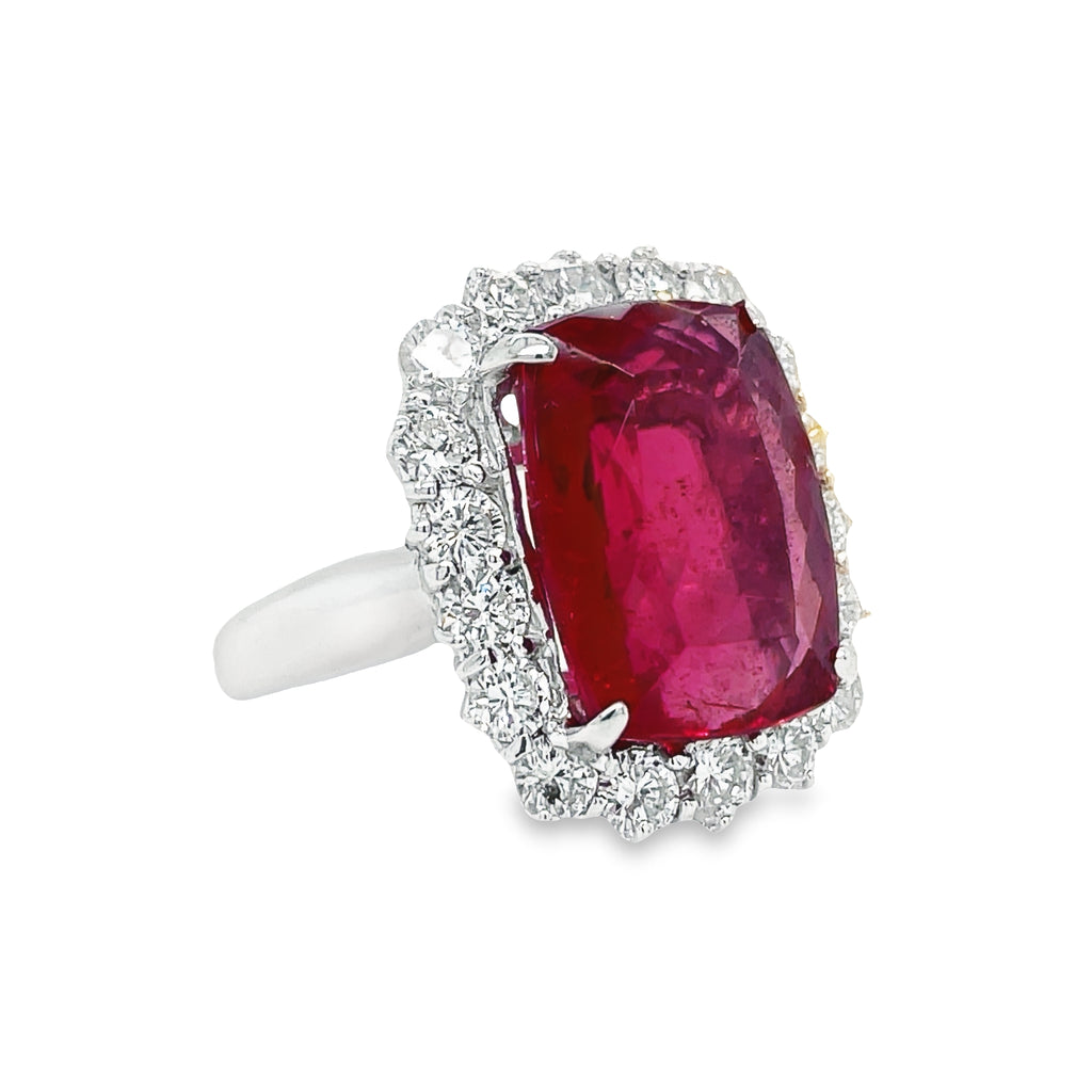 This exquisite modified radiant cut Rubilite & Diamond Cocktail Ring is a stunning statement piece. Its captivating rubilite tourmaline center stone is accented by a halo of glittering round diamonds with a total carat weight of 1.92 cts. Set in luxurious platinum, this piece radiates elegance and sophistication.