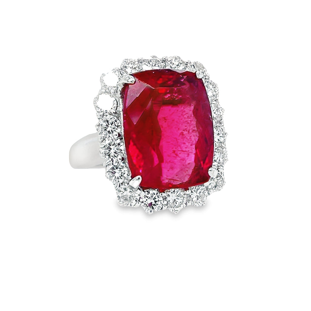 This exquisite modified radiant cut Rubilite & Diamond Cocktail Ring is a stunning statement piece. Its captivating rubilite tourmaline center stone is accented by a halo of glittering round diamonds with a total carat weight of 1.92 cts. Set in luxurious platinum, this piece radiates elegance and sophistication.