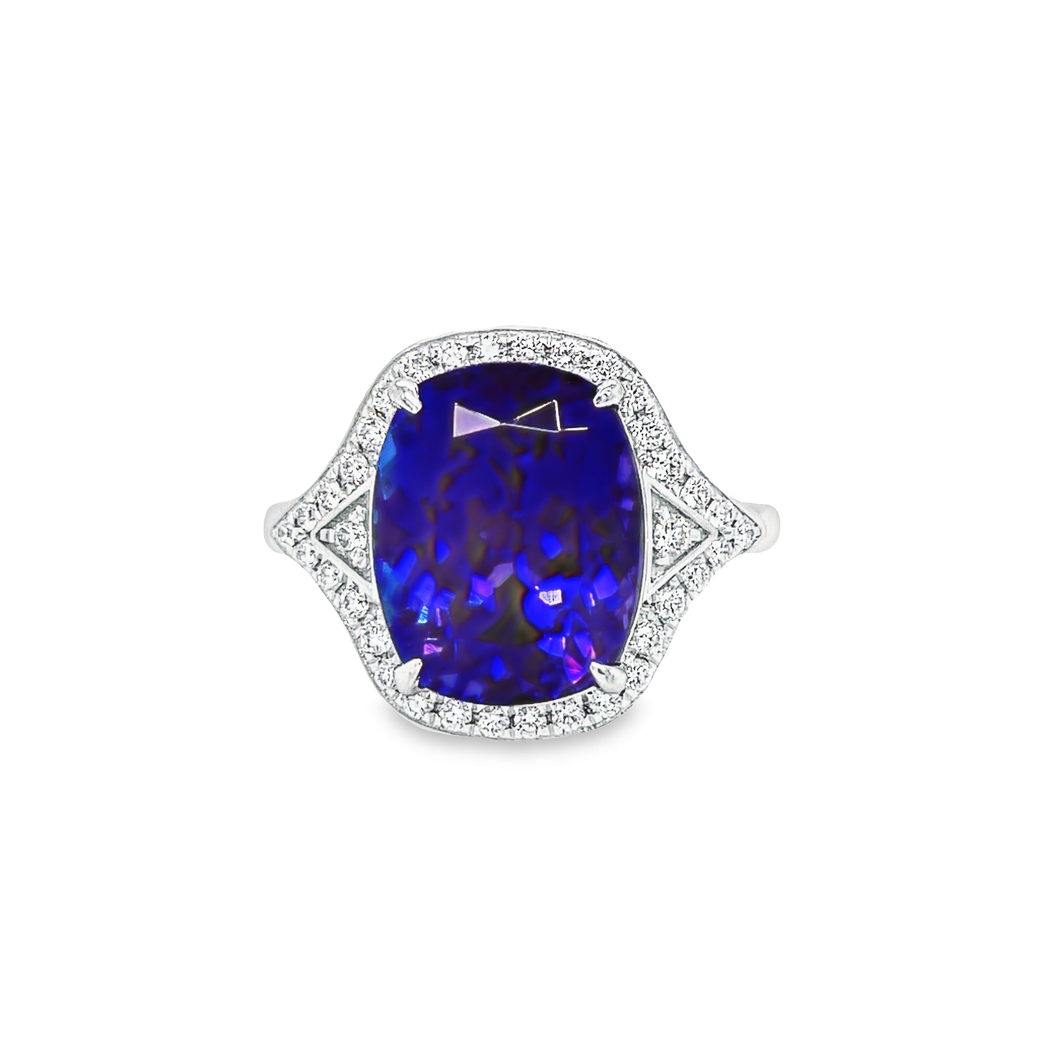 This exquisite modified radiant cut Tanzanite 6.75 cts & Diamond Cocktail Ring is a stunning statement piece. Its captivating Tanzanite center stone is accented by a halo of glittering round diamonds. Set in luxurious platinum, this piece radiates elegance and sophistication.