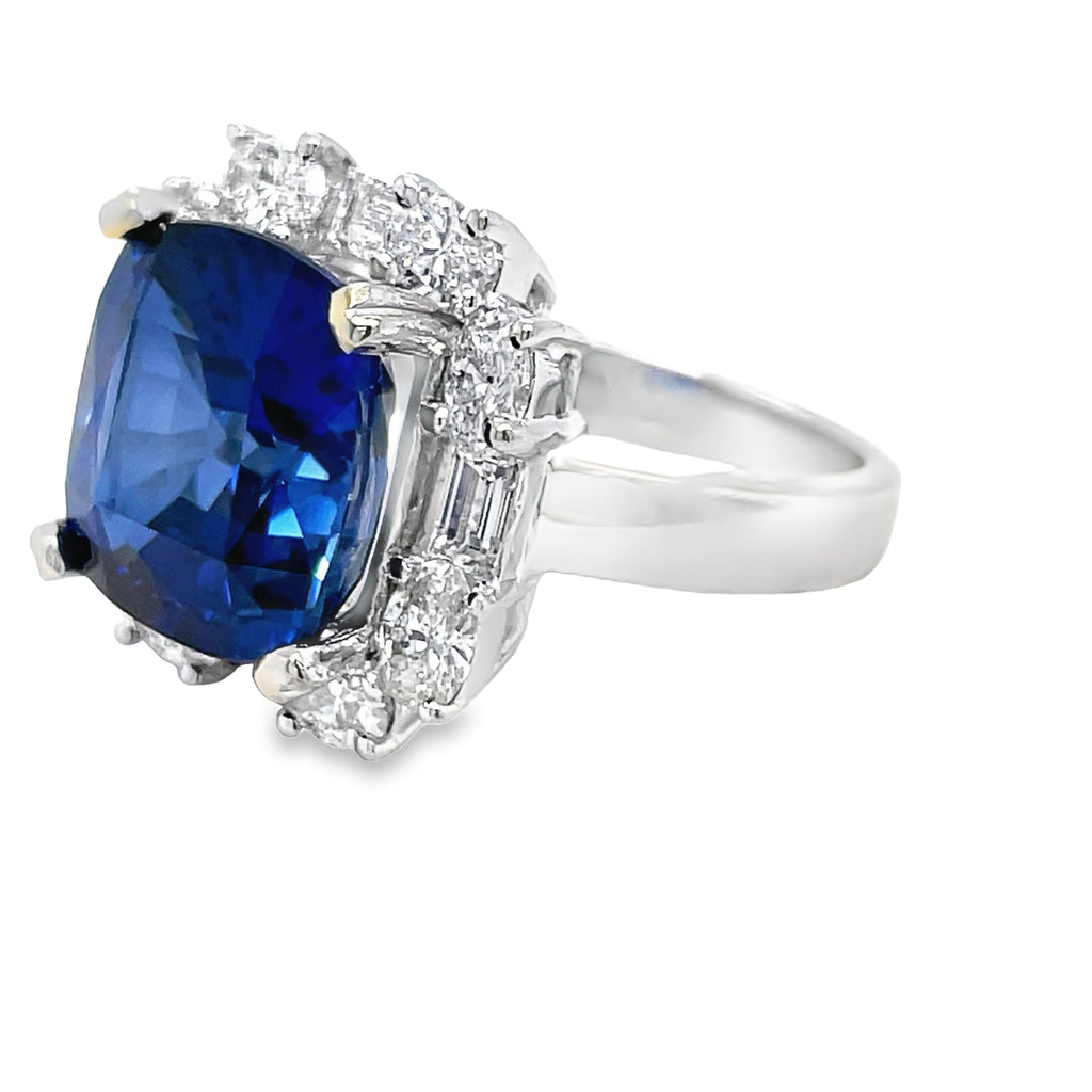 Step into elegance with our Cushion Cut Tanzanite & Diamond Cocktail Ring. Featuring a stunning 9.20 carat cushion cut tanzanite stone, accented by 80 round diamonds 1.28 cts and 4 baguette diamonds 0.54 cts. Set in luxurious 18k white gold. Elevate your style and make a statement with this exquisite ring!