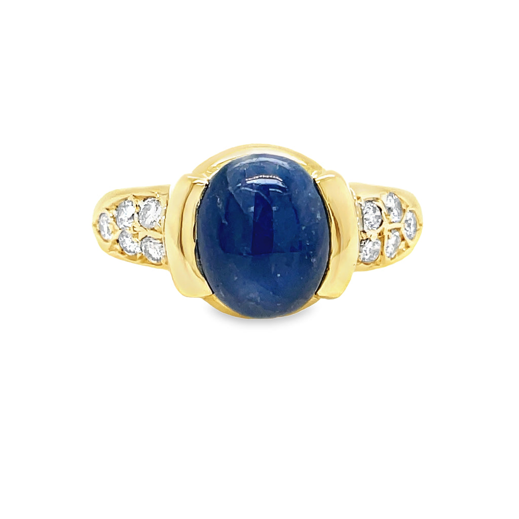 Elevate your style with our Blue Sapphire Cabochon Ring. Crafted with a mesmerizing cabochon sapphire and set in 18k yellow gold, this ring is a true statement piece. Adorned with 0.35 cts of round diamonds, it will add a touch of elegance and sophistication to any outfit.