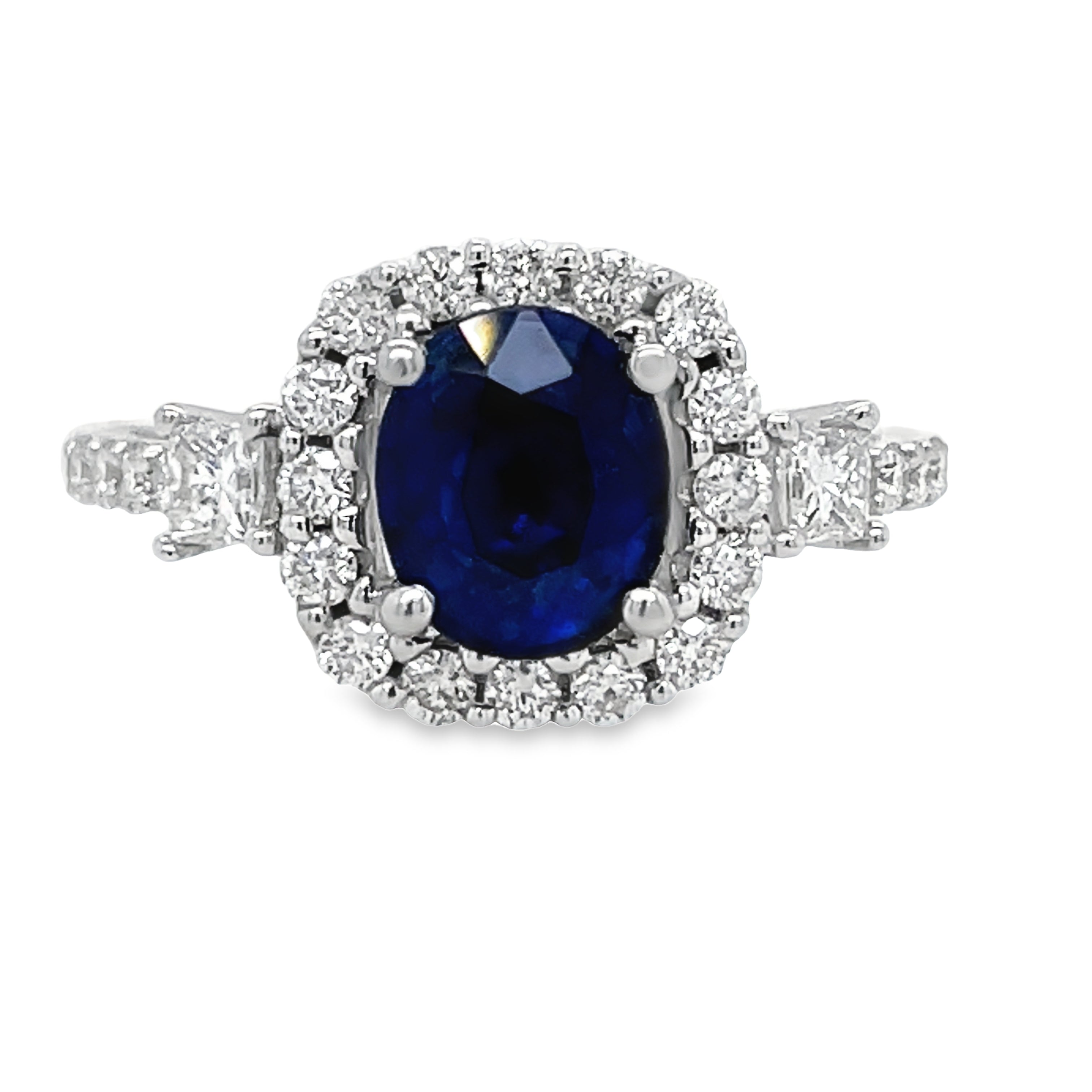 Experience luxury and elegance with our Oval Sapphire Diamond Bezel Ring. Featuring a stunning oval sapphire surrounded by princess cut and round diamonds totaling 0.59 cts, all set in a beautiful diamond bezel on an 18k white gold band. Make a statement that exudes sophistication and style.