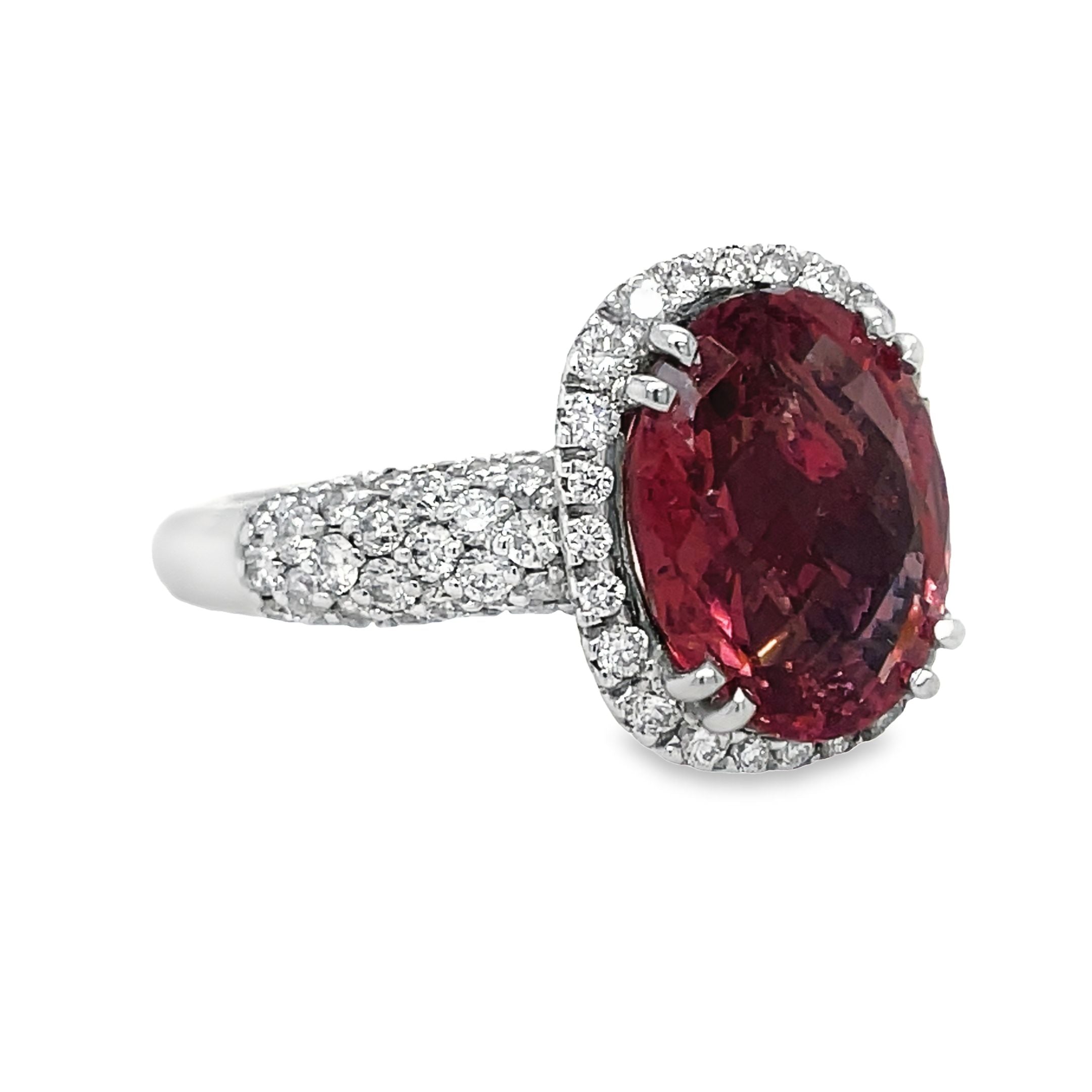 Expertly crafted with a 4.47 carat oval tourmaline and 1.15 carats of diamond pave set in 18k white gold, this ring exudes elegance and luxury. Add a pop of color and sparkle to any outfit with this one-of-a-kind piece.