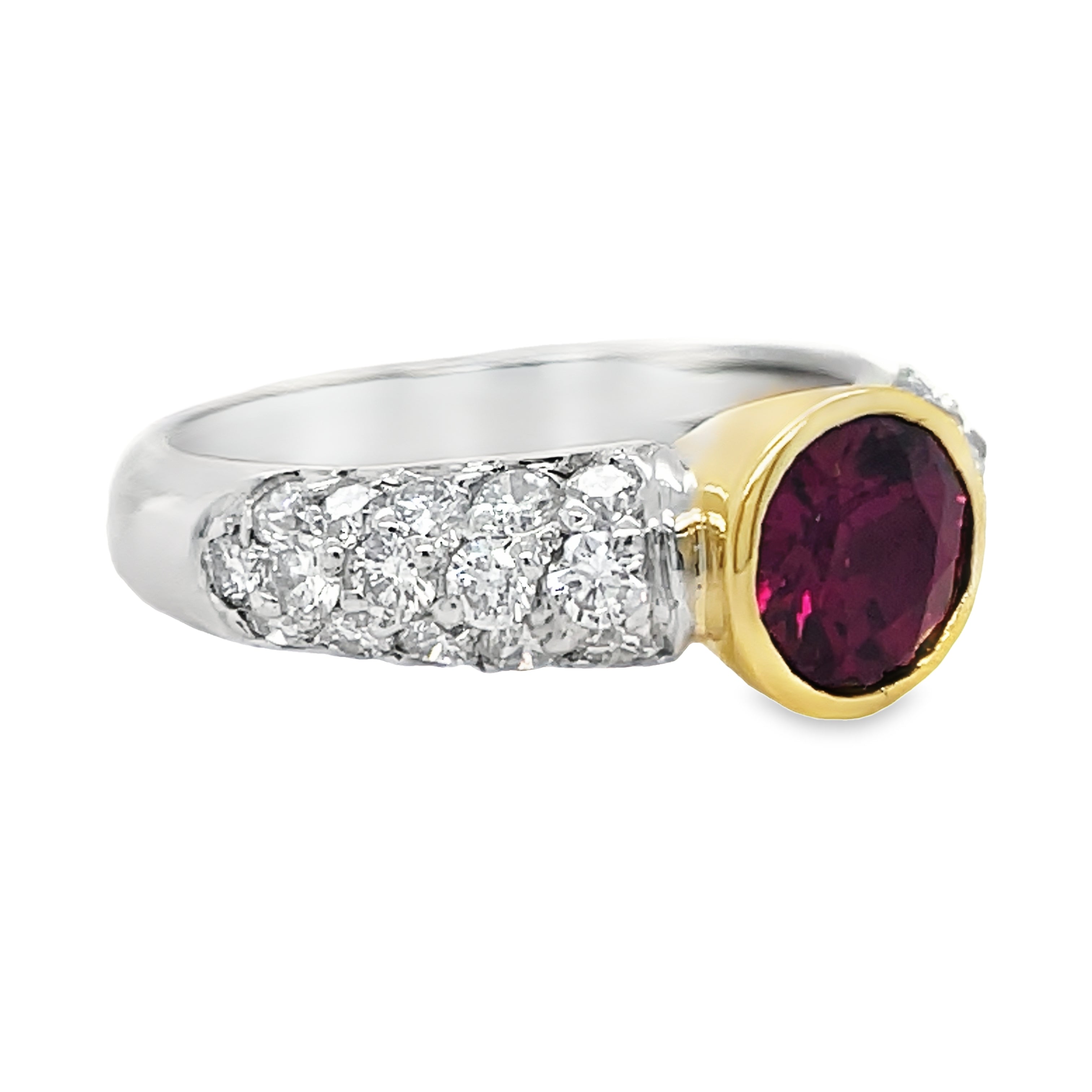This exquisite Two-Tone Rhodolite Diamond Ring features a vibrant rhodolite stone bezel set in 18k two tone gold, accented with round diamonds totaling 1.05 carats. Elevate your style with this unique and stunning piece.