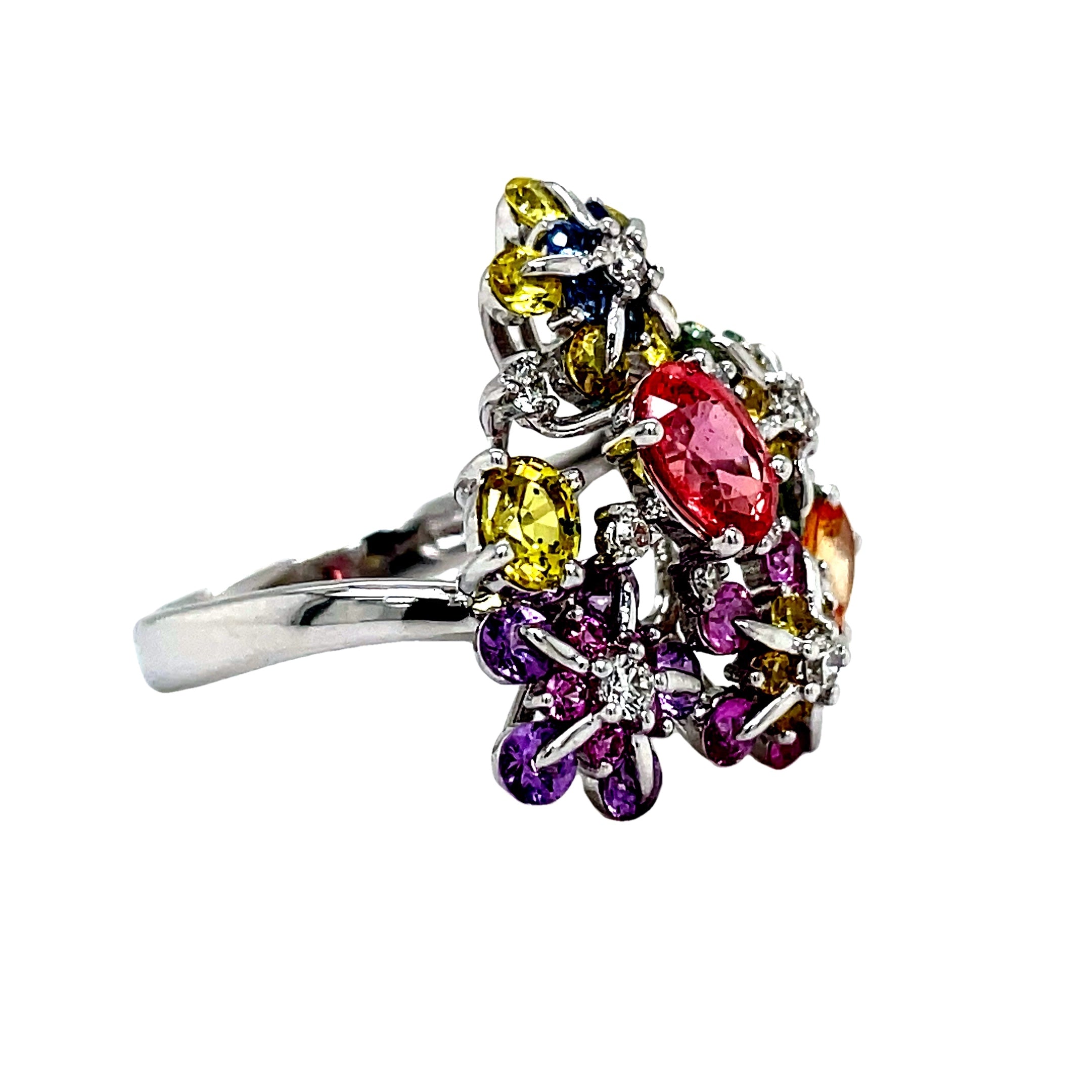 Indulge in the delicate beauty of our Multicolor Sapphire &amp; Diamond Flower Motif Ring. Adorned with 3.22 carats of multicolored sapphire stones and 0.17 carats of round diamonds, this flower-inspired ring exudes elegance and sophistication. Crafted with 18k white gold, it is a true masterpiece of refined luxury.