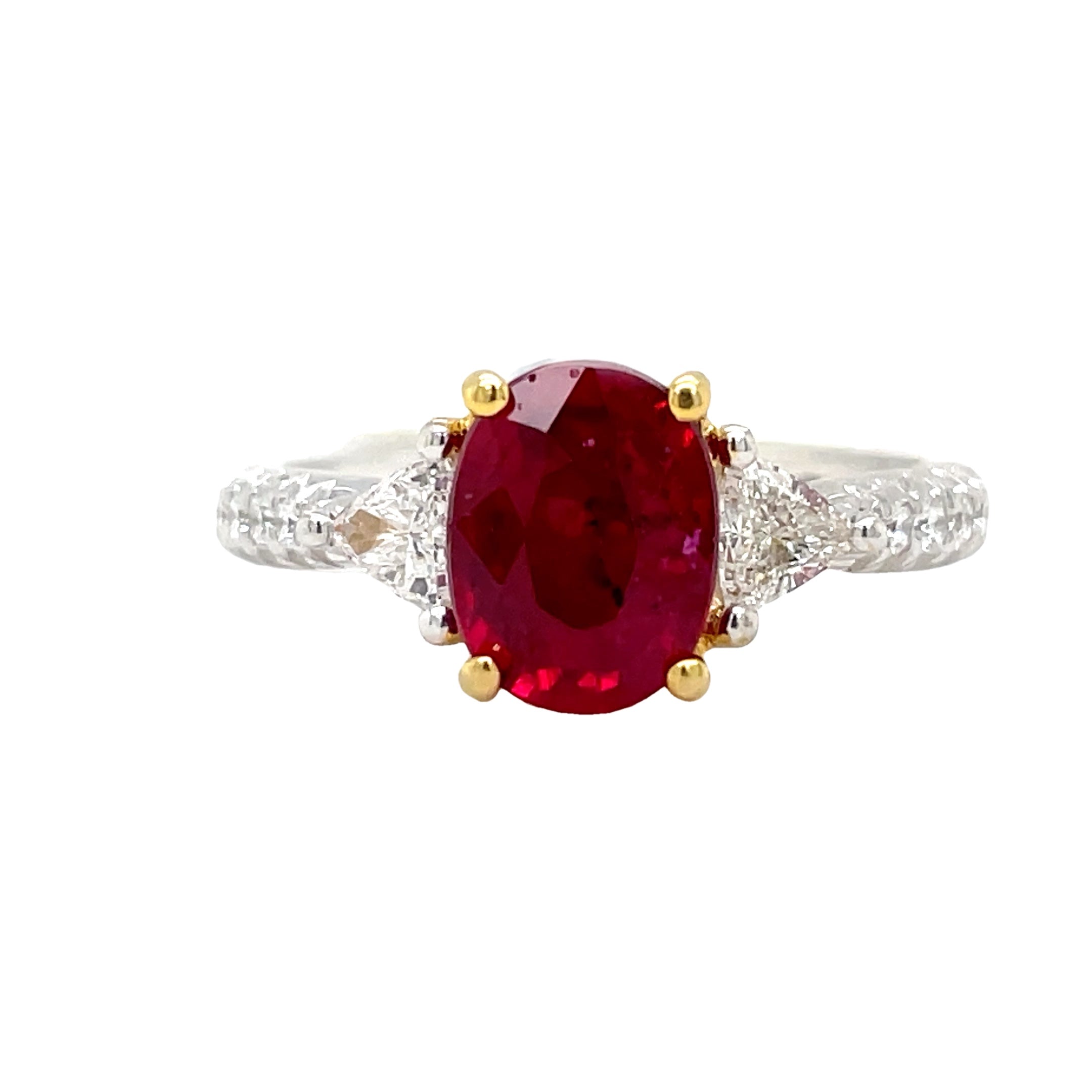 Indulge in luxury with our Oval Madagascar Ruby and Trillion Diamond Ring. This exquisite piece features a stunning oval ruby from Madagascar, weighing 1.71 carats, surrounded by 0.58 carats of round diamonds set in 18k white gold. The perfect combination of sophistication and opulence, with yellow gold prongs and head adding a touch of elegance.