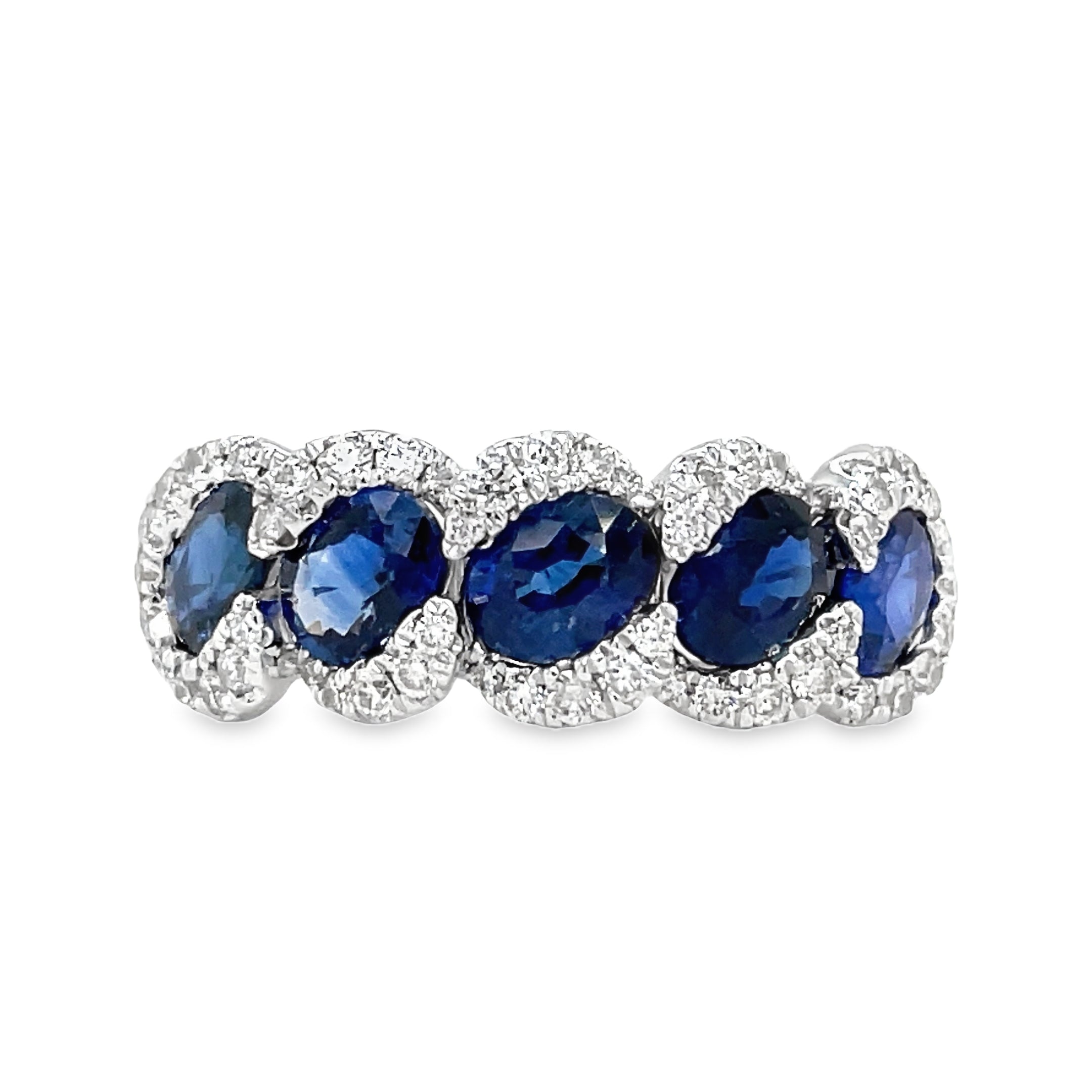 his 18k white gold ring features five stunning oval sapphires, totaling 2.32 carats, and sparkling round diamonds with a total weight of 0.43 carats. The perfect combination of elegance and femininity, this ring is sure to make a statement.