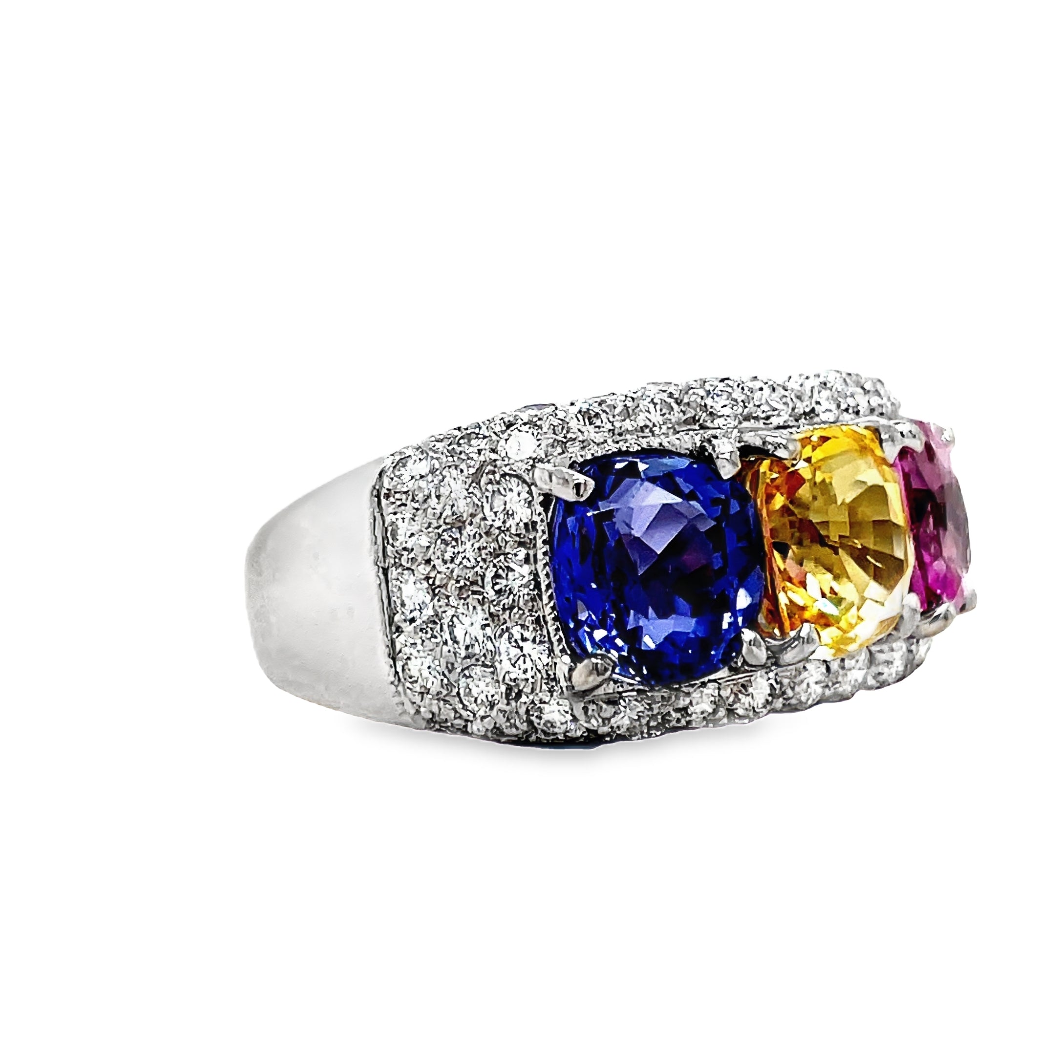 Introducing our Tricolor Sapphire Ring, a true masterpiece. The 4.50 cts of oval shaped pink, yellow, and blue sapphires create a captivating combination, set in 18k white gold. Adorned with 1.50 cts of pave set diamonds, this ring exudes luxury and elegance. Elevate your style with this exclusive piece.