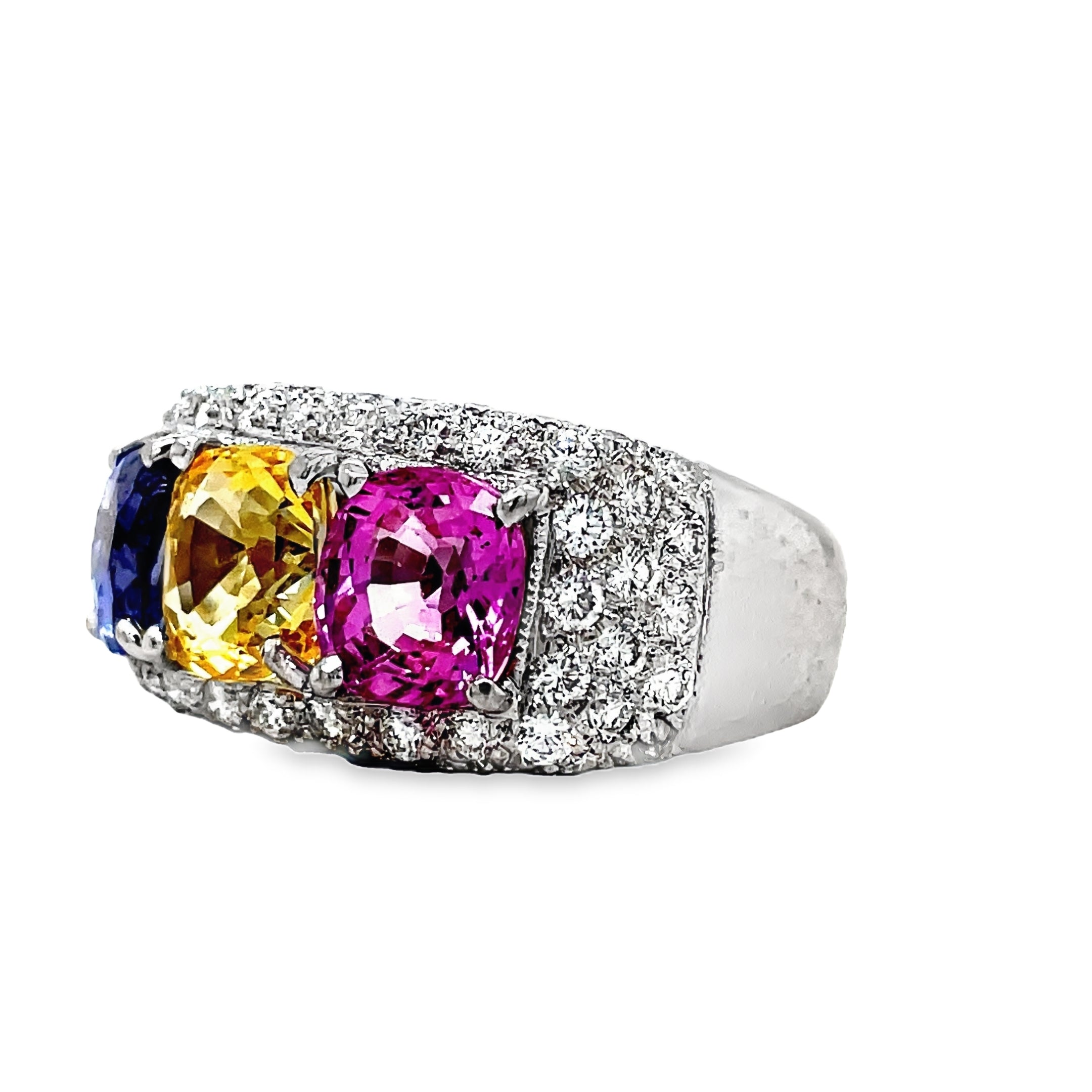 Introducing our Tricolor Sapphire Ring, a true masterpiece. The 4.50 cts of oval shaped pink, yellow, and blue sapphires create a captivating combination, set in 18k white gold. Adorned with 1.50 cts of pave set diamonds, this ring exudes luxury and elegance. Elevate your style with this exclusive piece.