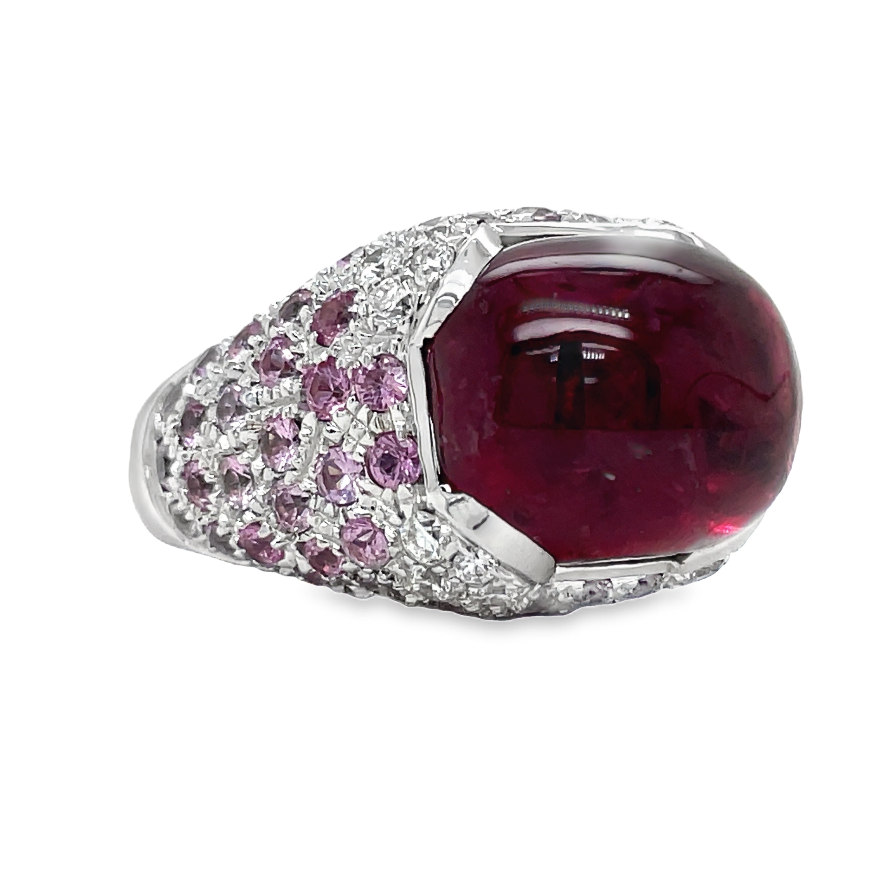 Elevate your style with this luxurious Italian-made ring. Crafted with 18k white gold, it features a stunning ruby cabochon (4.88 cts) and a vibrant pink topaz (7.60 cts). Adorned with round diamonds (0.64 cts) in a pave setting, this ring exudes elegance and sophistication.