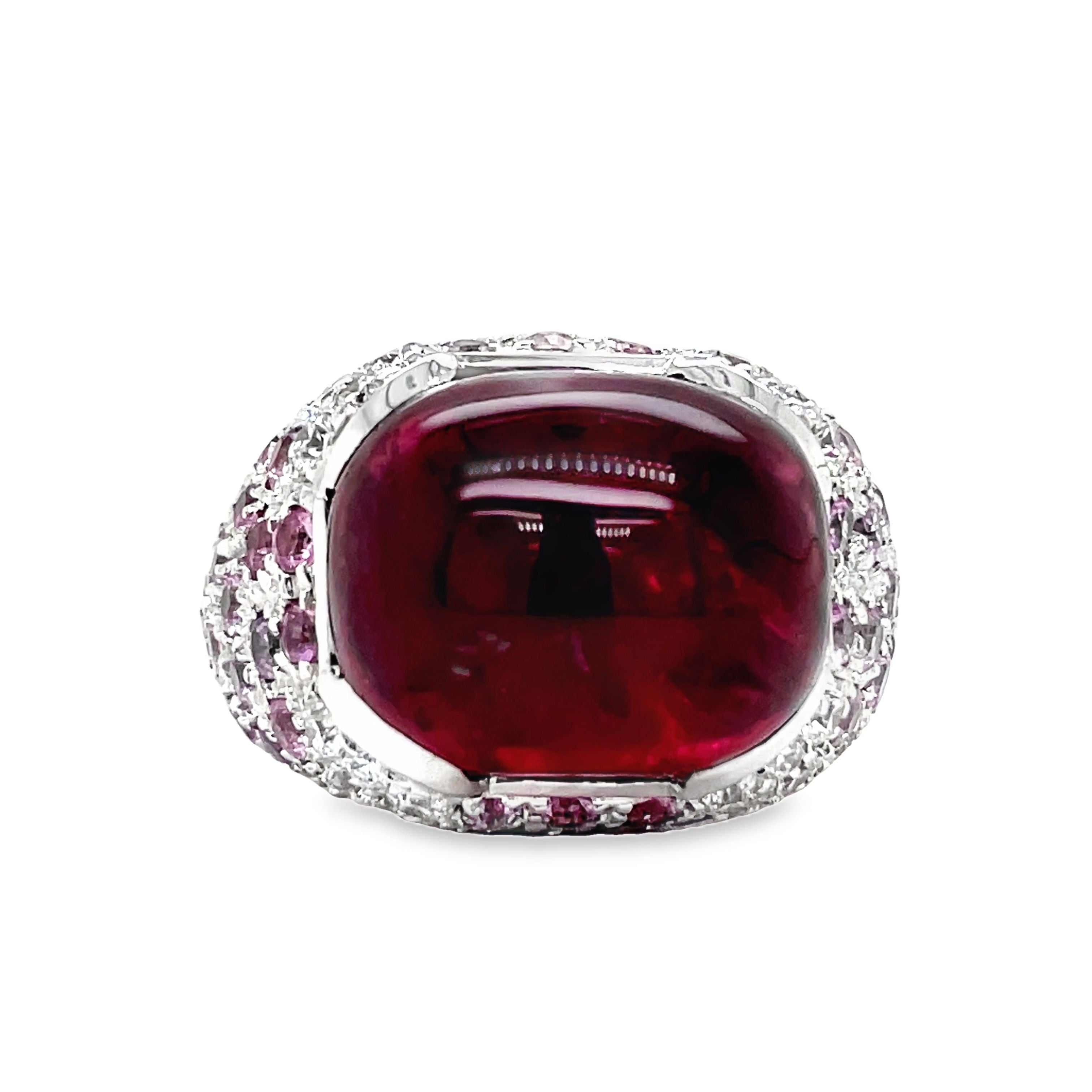 Elevate your style with this luxurious Italian-made ring. Crafted with 18k white gold, it features a stunning ruby cabochon (4.88 cts) and a vibrant pink topaz (7.60 cts). Adorned with round diamonds (0.64 cts) in a pave setting, this ring exudes elegance and sophistication.