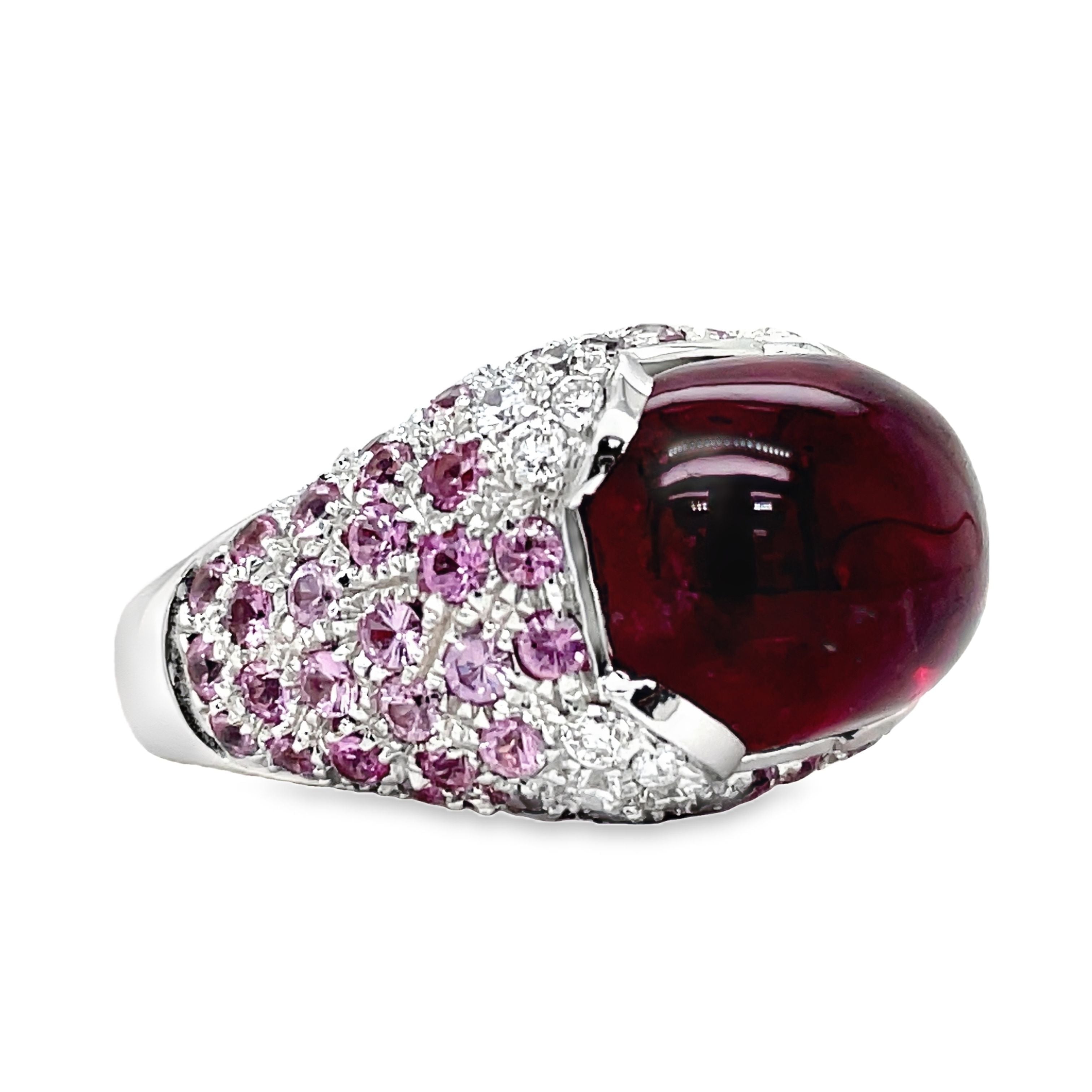 Elevate your style with this luxurious Italian-made ring. Crafted with 18k white gold, it features a stunning ruby cabochon (4.88 cts) and a vibrant pink topaz (7.60 cts). Adorned with round diamonds (0.64 cts) in a pave setting, this ring exudes elegance and sophistication.