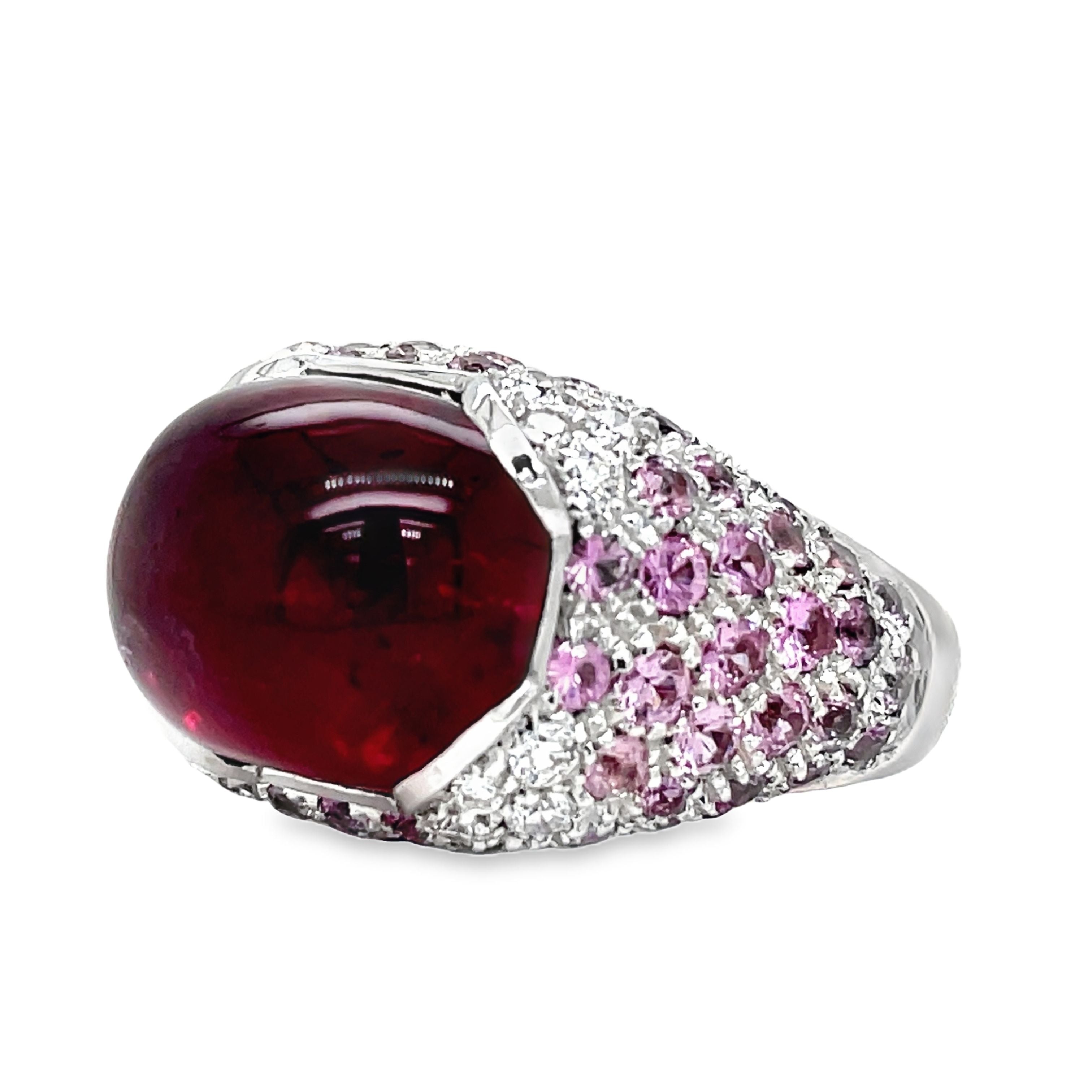 Elevate your style with this luxurious Italian-made ring. Crafted with 18k white gold, it features a stunning ruby cabochon (4.88 cts) and a vibrant pink topaz (7.60 cts). Adorned with round diamonds (0.64 cts) in a pave setting, this ring exudes elegance and sophistication.