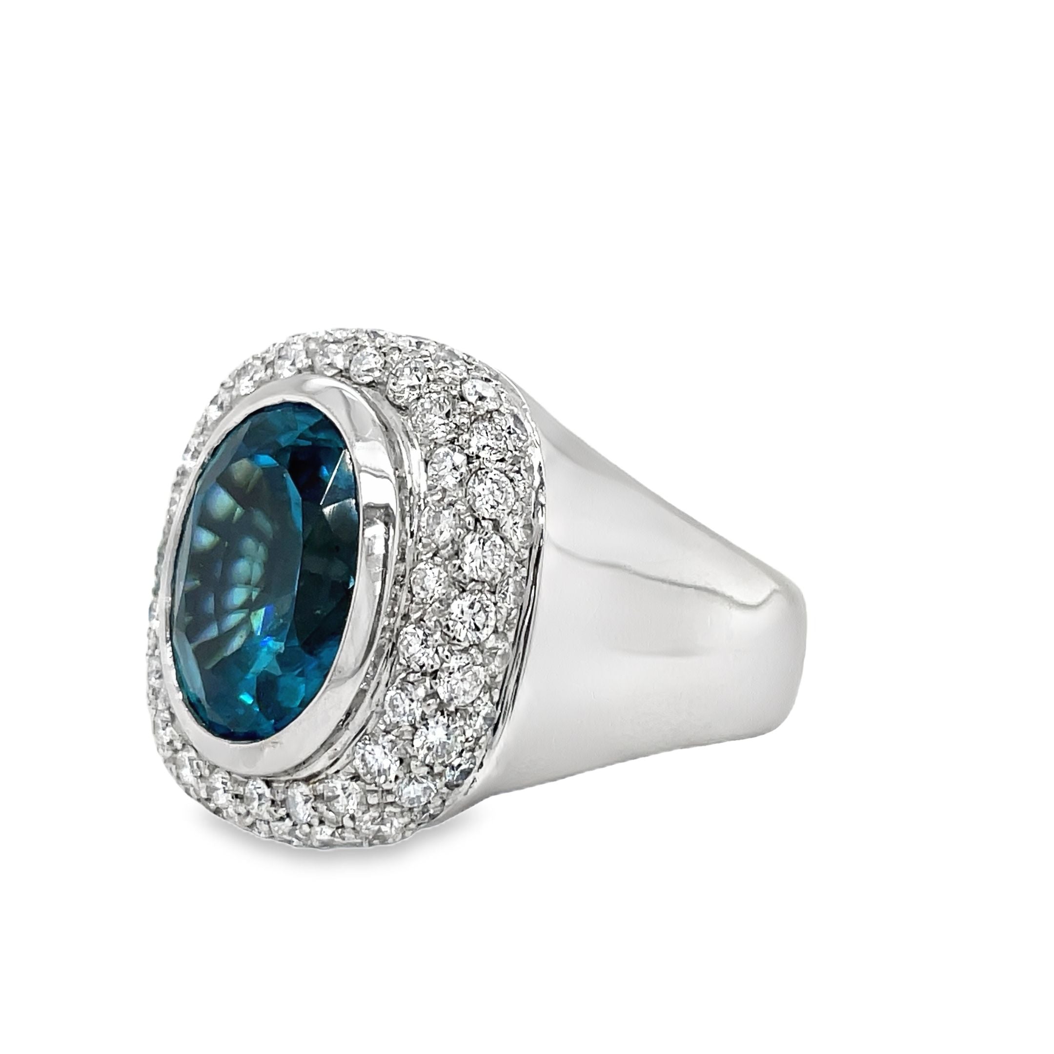 Indulge in luxury with our exquisite Italian made Blue Zircon and Diamond Cocktail Ring. Crafted with 18k white gold, the oval shape zircon (10.68 cts) shimmers with elegance, while the round diamonds (1.35 cts) add a touch of glamour. The wide gold ring completes this sophisticated and exclusive piece, making it a must-have for any fashion-forward woman.