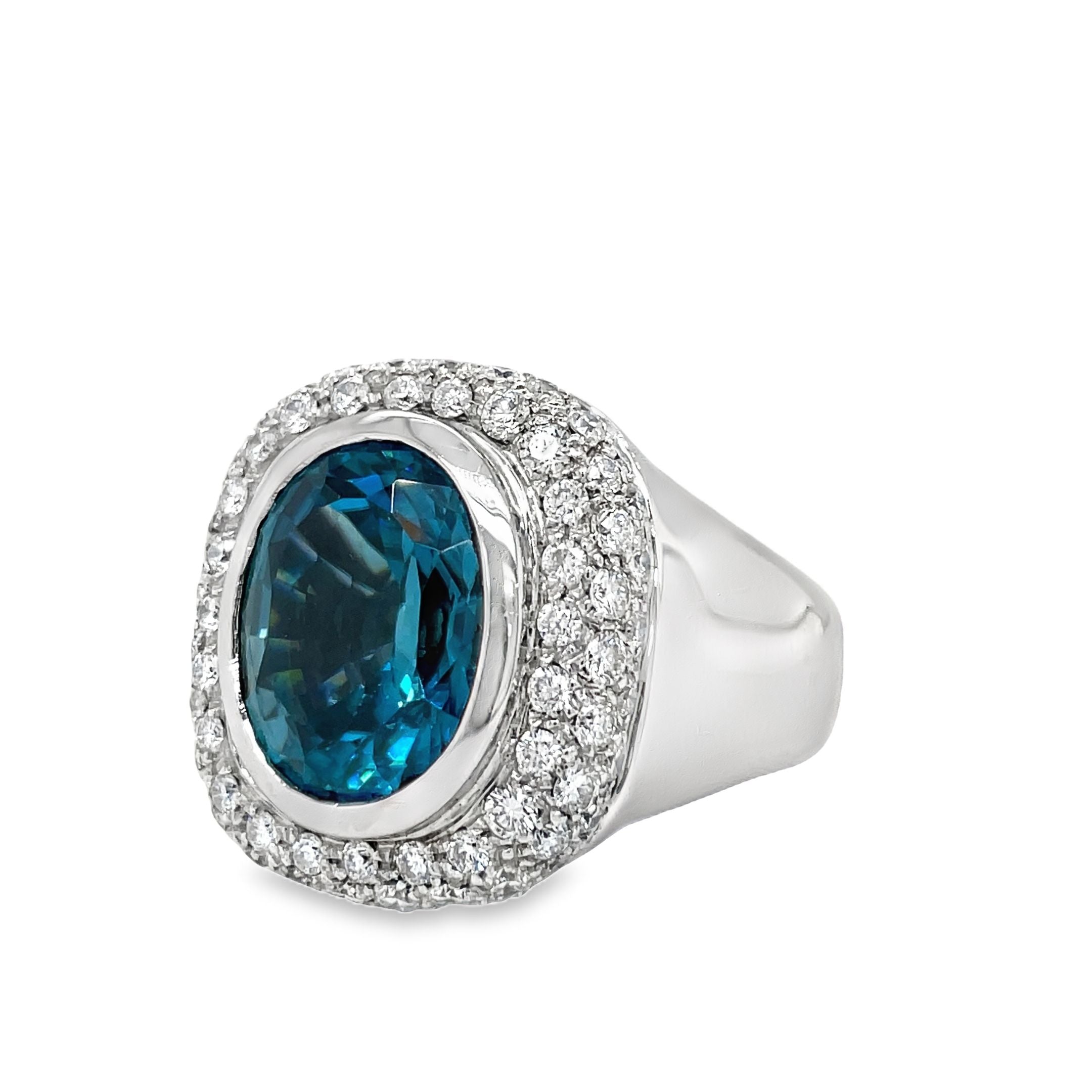 Indulge in luxury with our exquisite Italian made Blue Zircon and Diamond Cocktail Ring. Crafted with 18k white gold, the oval shape zircon (10.68 cts) shimmers with elegance, while the round diamonds (1.35 cts) add a touch of glamour. The wide gold ring completes this sophisticated and exclusive piece, making it a must-have for any fashion-forward woman.