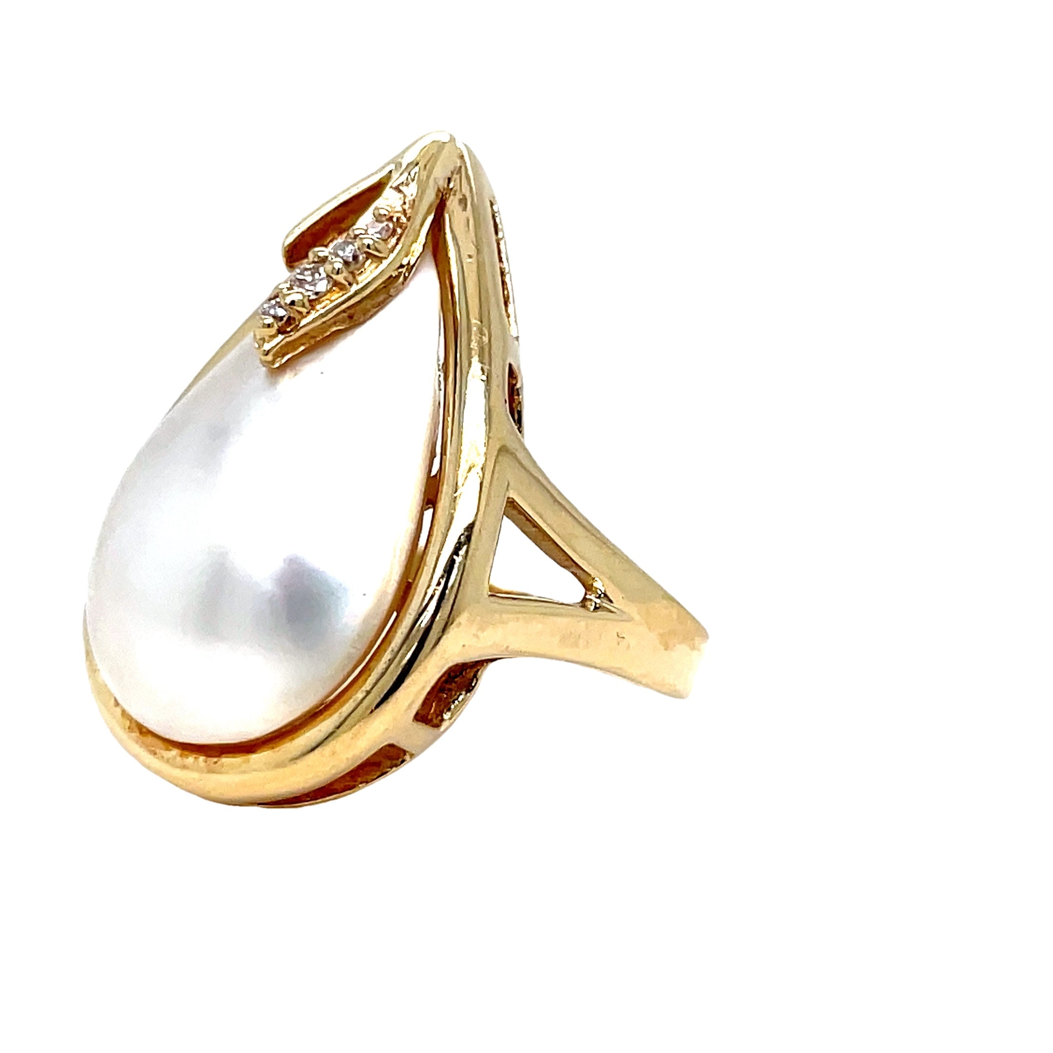 Indulge in timeless elegance with our Pear Shape Mabe Pearl Yellow Gold Ring. Crafted in 14k yellow gold, the pear-shaped Mabe pearl sits delicately atop a bed of round diamonds. This luxurious ring is the perfect accessory for any occasion.