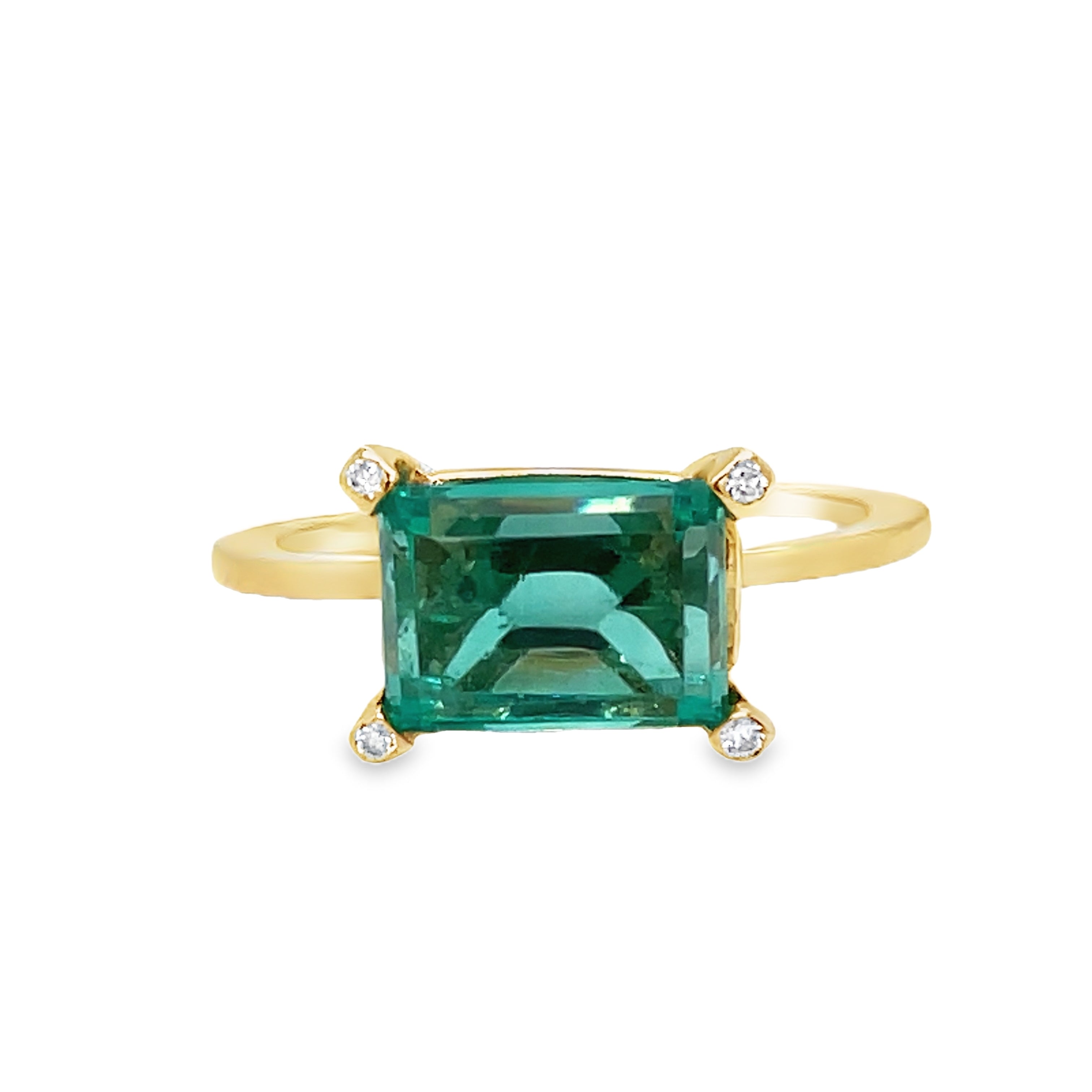 Indulge in luxury with our Horizontal Emerald Cut Emerald Ring. Crafted with 14k yellow gold, this ring features a stunning emerald cut emerald set upside down, accented by four small diamonds on each corner. The horizontal setting adds a unique touch of elegance to this timeless piece. Elevate your style with this exclusive ring.