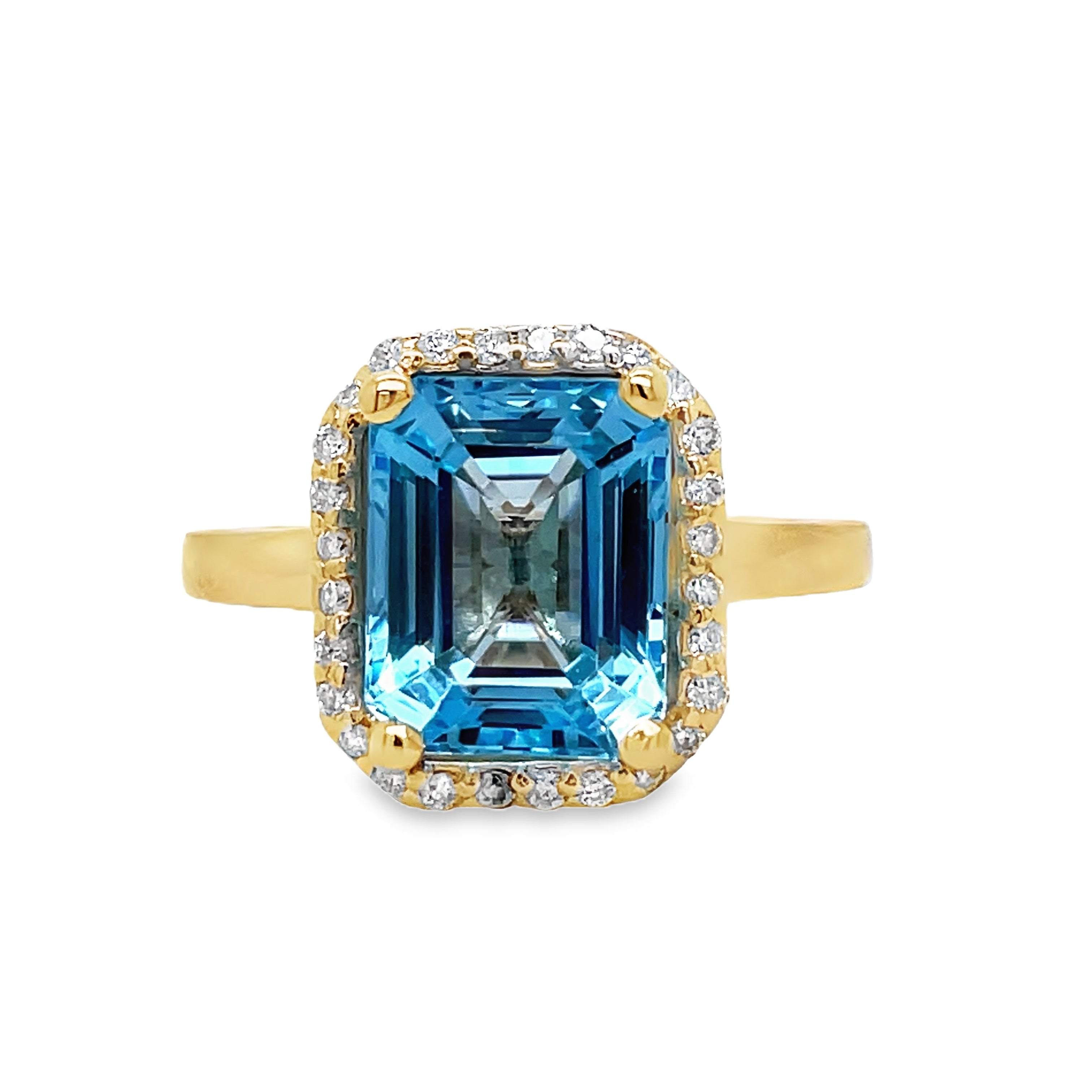 Indulge in the exquisite elegance of this Emerald Cut Blue Topaz Diamond Halo Ring. Crafted in 14k yellow gold, the cathedral style setting highlights a stunning emerald cut Blue Topaz, surrounded by sparkling round diamonds totaling 0.40 carats. A true masterpiece, perfect for any sophisticated and exclusive individual.