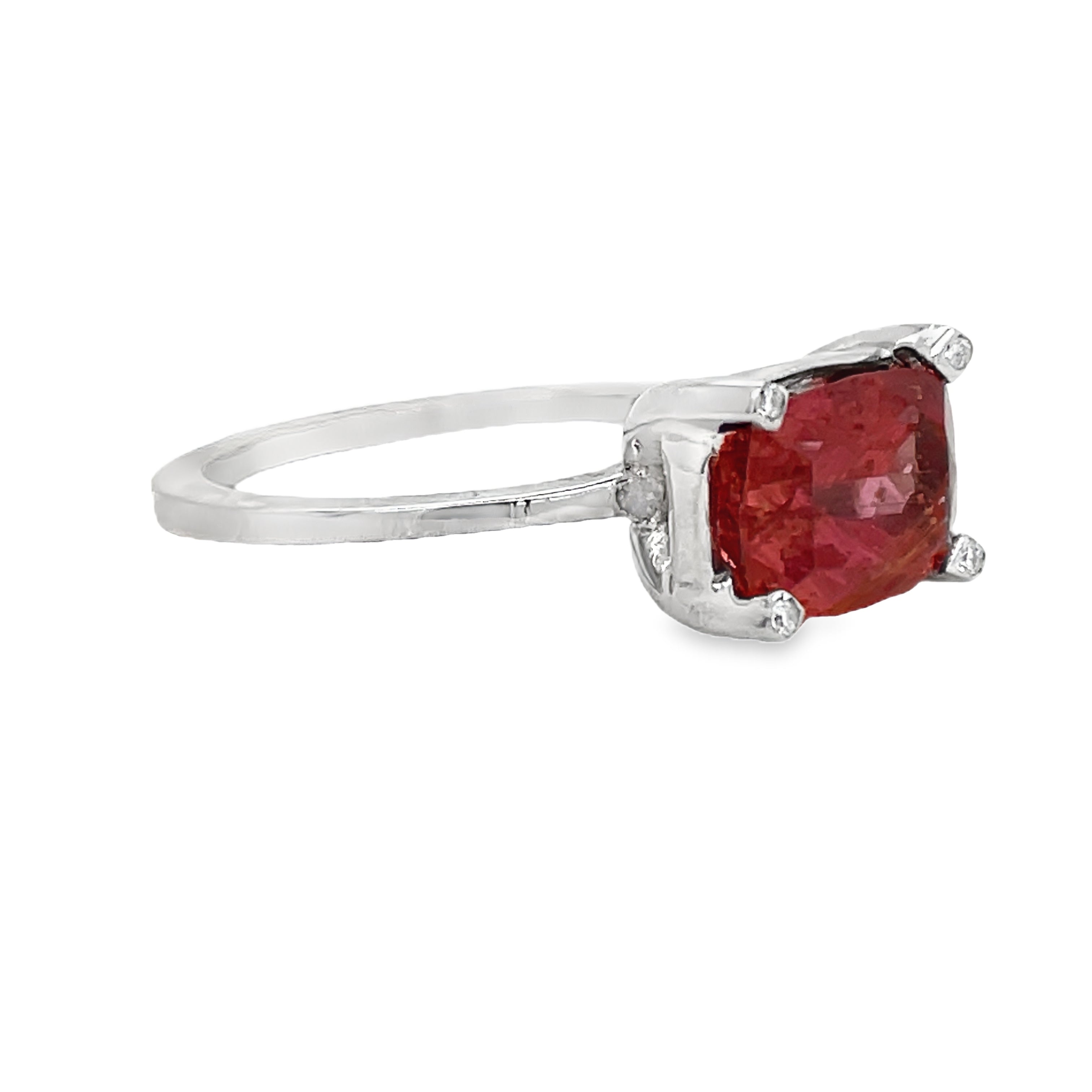 Indulge in luxury with our Horizontal Oval Cut Pink Topaz Ring. Crafted with 14k white gold, this ring features a stunning oval cut pink tourmaline, accented by four small diamonds on each corner. The horizontal setting adds a unique touch of elegance to this timeless piece. Elevate your style with this exclusive ring.