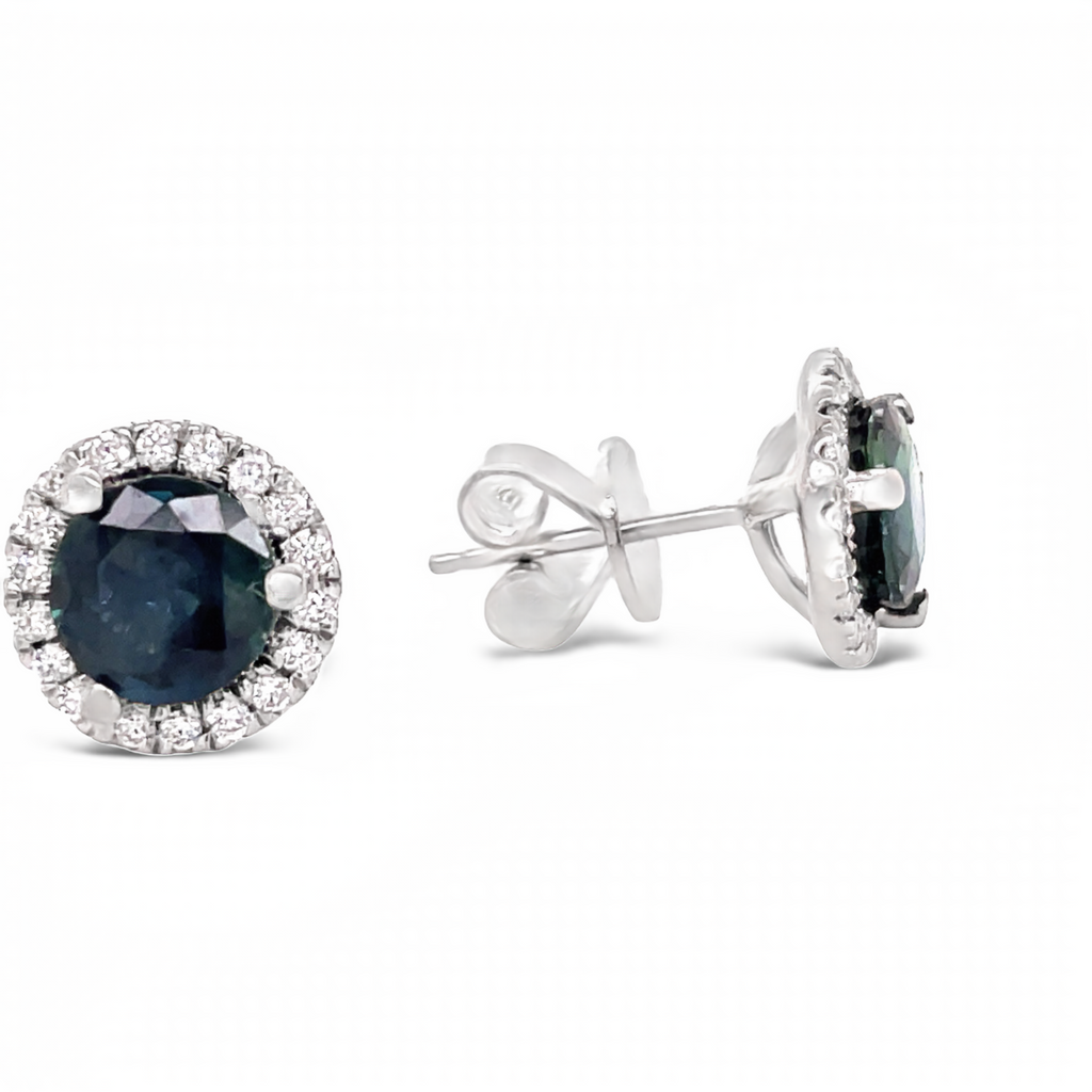 These beautiful medium blue sapphire and diamond stud earrings are crafted in 18k white gold. They feature 2.00 cts round faceted sapphires and 0.50 cts round diamonds for a unique, and elegant look.