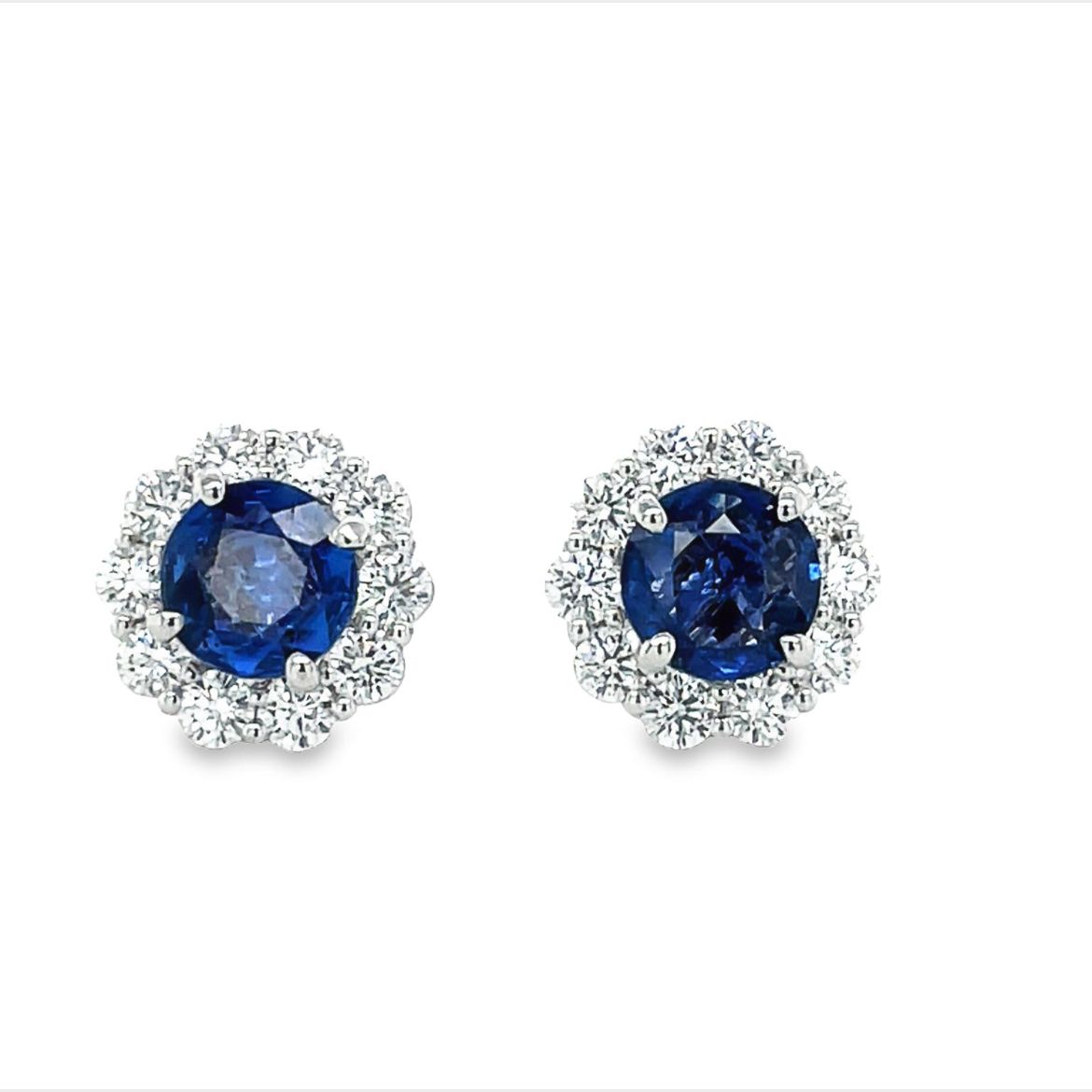 These beautiful medium blue sapphire and diamond stud earrings are crafted in 18k white gold. They feature 2.00 cts round faceted sapphires and 0.50 cts round diamonds for a unique, and elegant look.