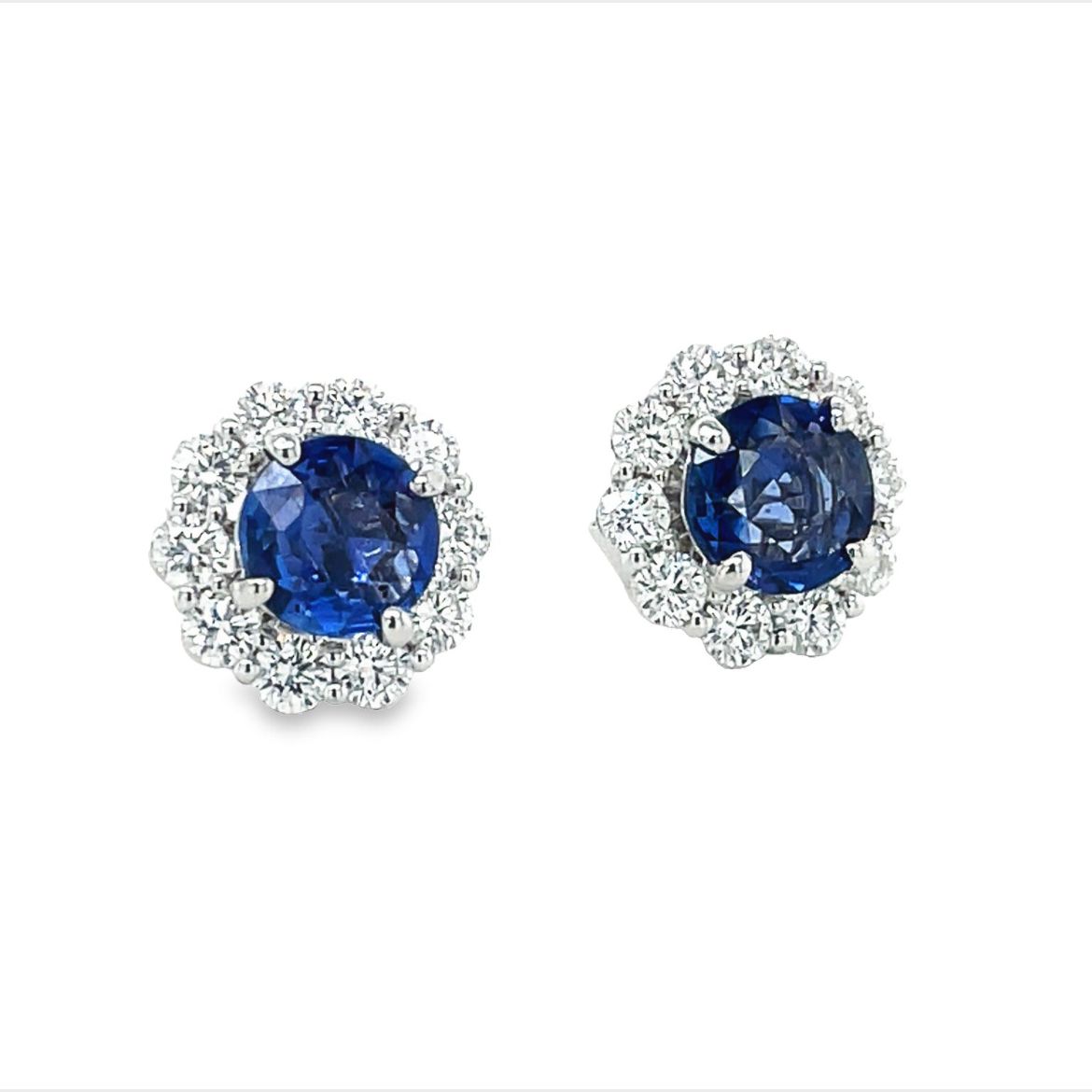 These beautiful medium blue sapphire and diamond stud earrings are crafted in 18k white gold. They feature 2.00 cts round faceted sapphires and 0.50 cts round diamonds for a unique, and elegant look.