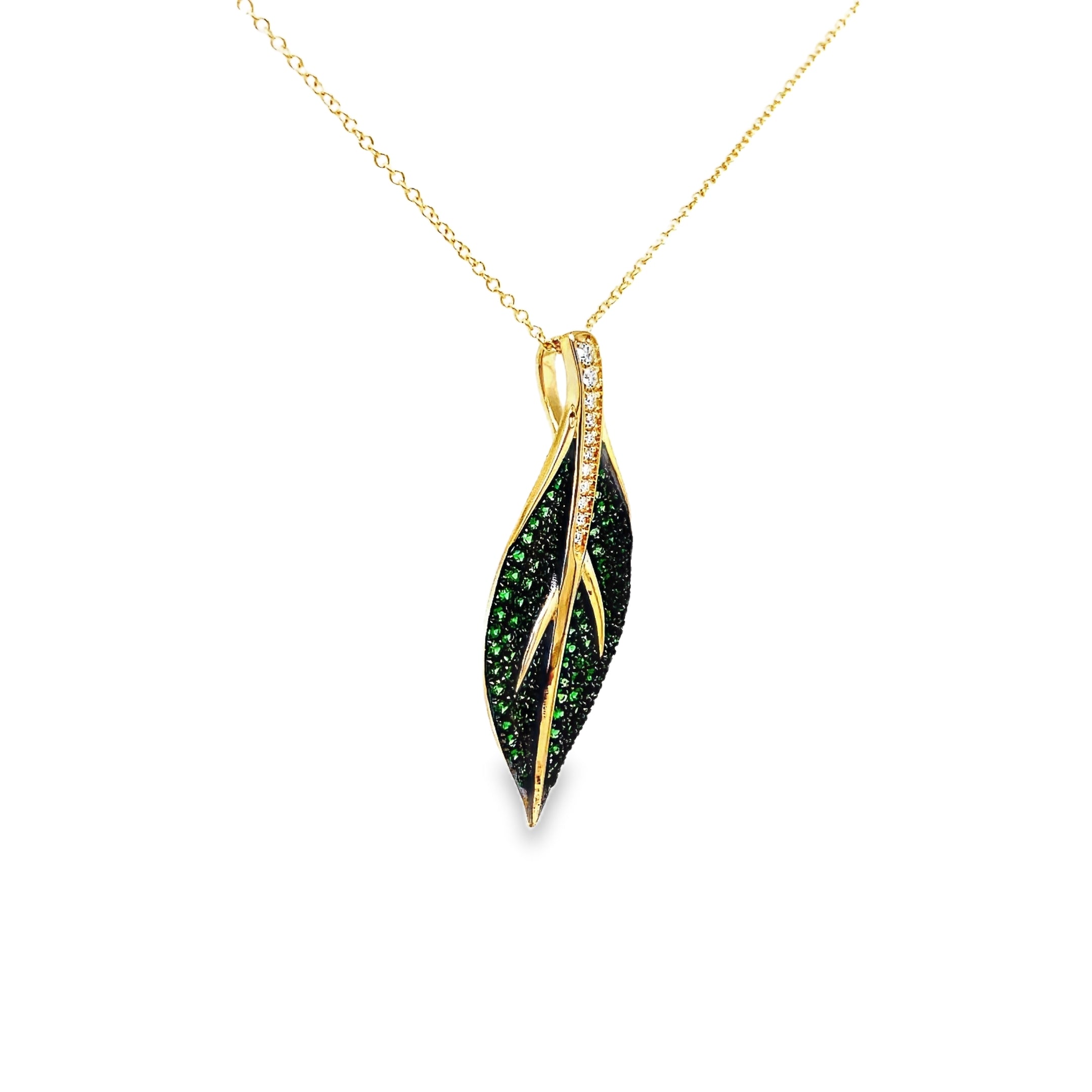 Indulge in luxury with our exquisite Tsavorite and Diamond Leaf Pendant Necklace. Crafted in 14k yellow gold, this necklace features brilliant tsavorite gems and round diamonds in a stunning leaf shape pendant. Elevate any outfit with this elegant and exclusive piece.

18" yellow gold chain optional $399.00