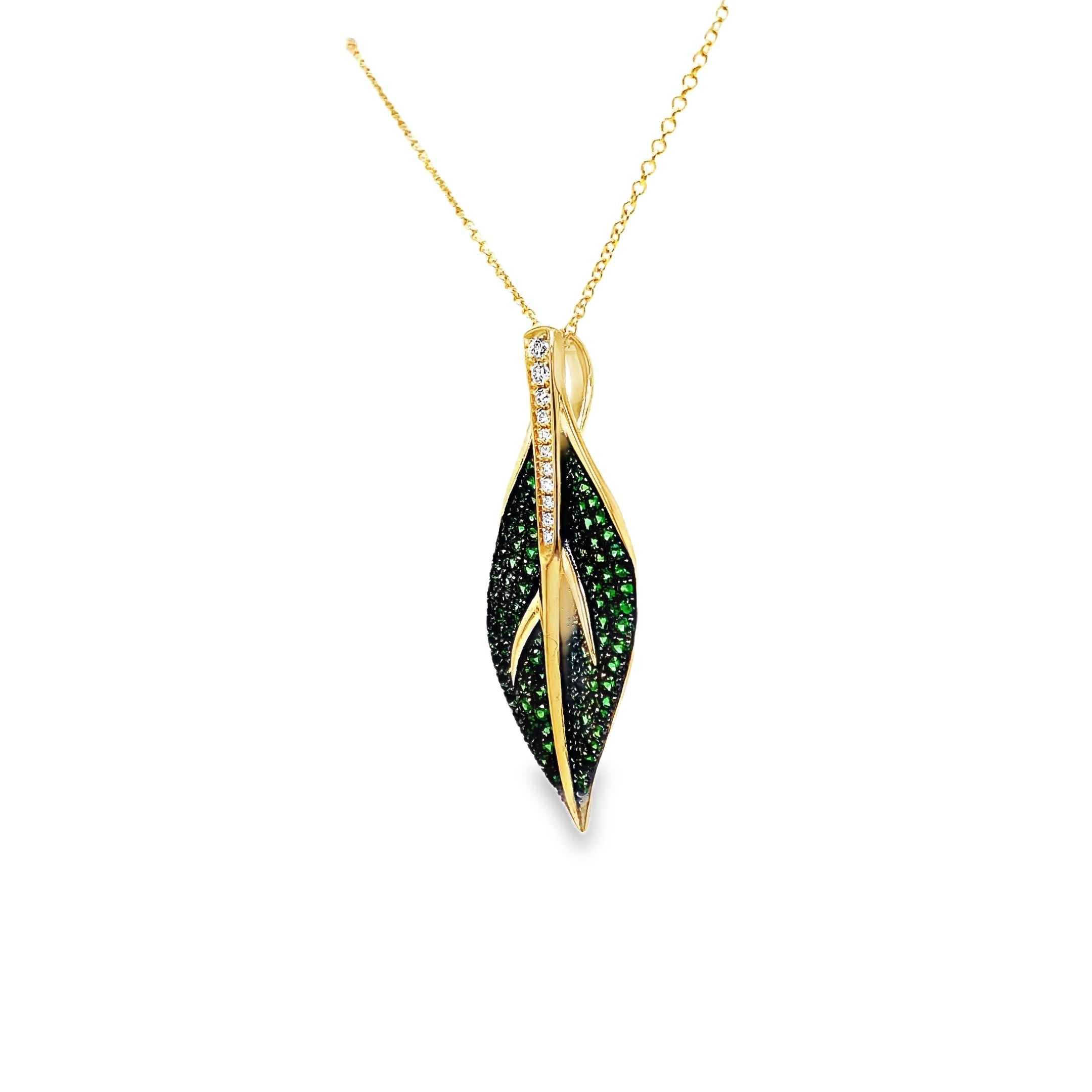 Indulge in luxury with our exquisite Tsavorite and Diamond Leaf Pendant Necklace. Crafted in 14k yellow gold, this necklace features brilliant tsavorite gems and round diamonds in a stunning leaf shape pendant. Elevate any outfit with this elegant and exclusive piece.

18" yellow gold chain optional $399.00