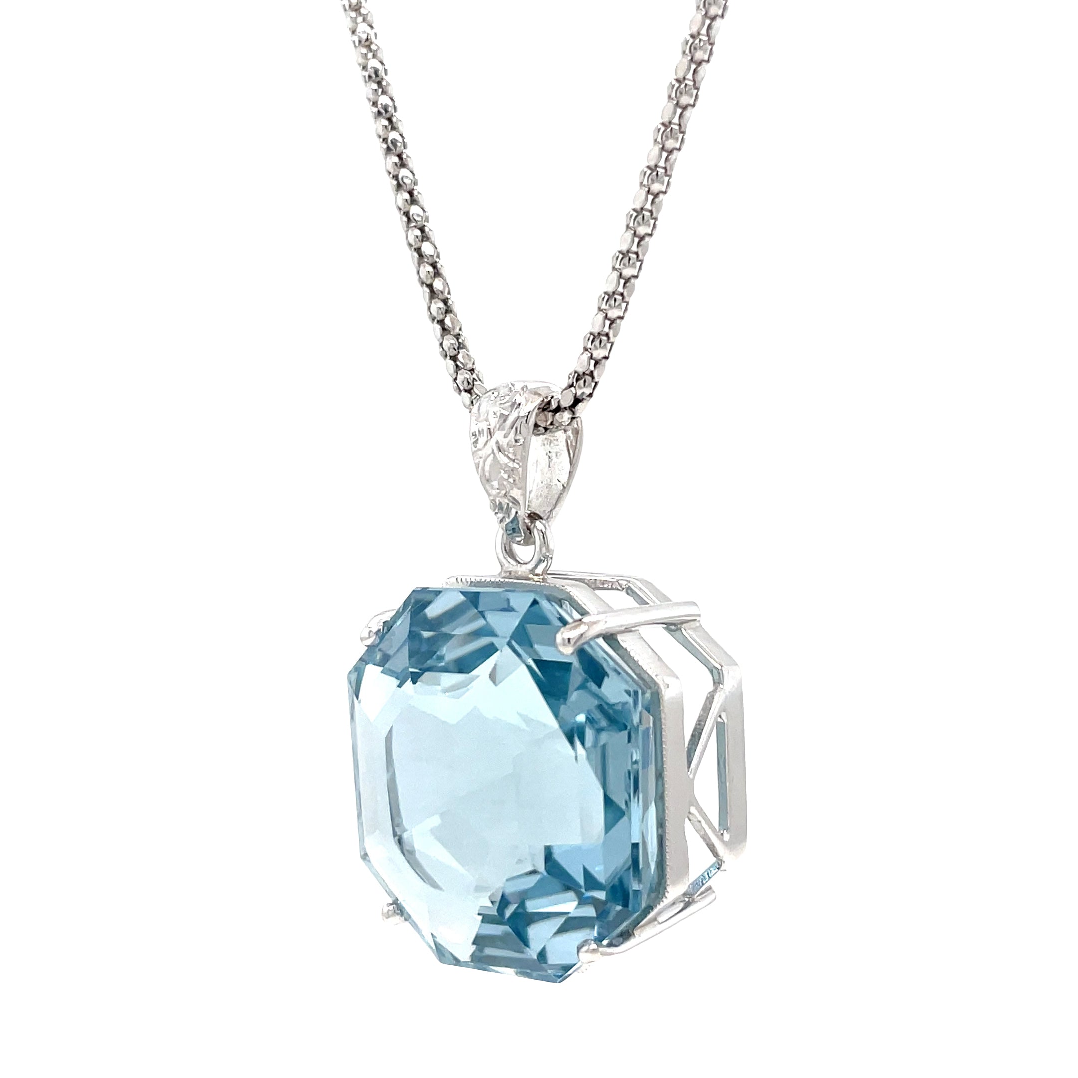 Expertly designed and crafted, our Aquamarine &amp; Diamond Necklace features a stunning octahedron aquamarine with a diamond bail. The custom-made white gold mounting adds a touch of elegance and is complemented by an Italian-made chain. Elevate any outfit with this eye-catching necklace. Chain is optional 20" long ($550)