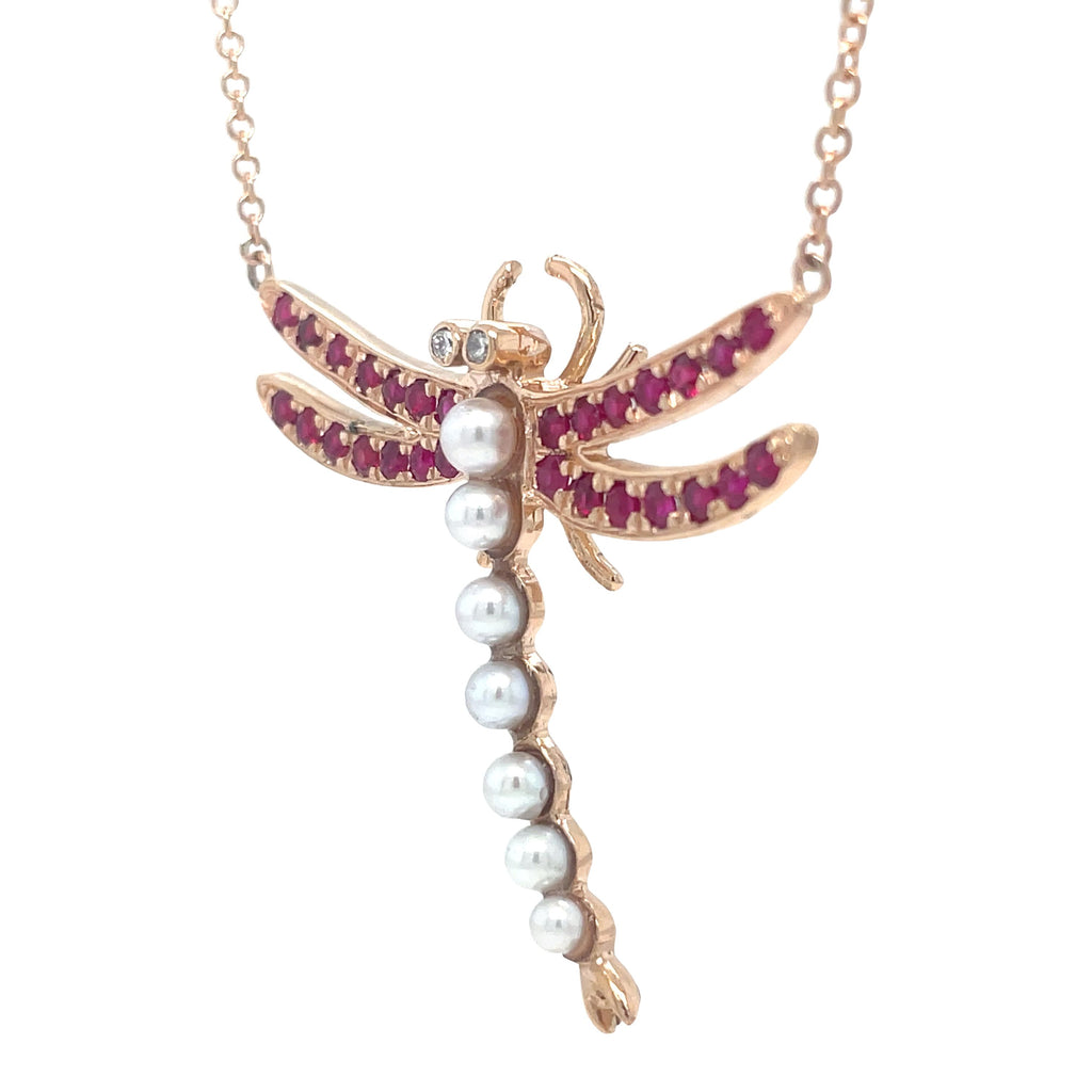 This one-of-a-kind custom made dragonfly pendant necklace is crafted with custom 18k rose gold and adorned with a stunning dragonfly pendant and 7 cultured pearls. The round rubies add a touch of elegance to this 16-inch long necklace made with pink and white sapphires. Elevate any outfit with this unique and luxurious piece!