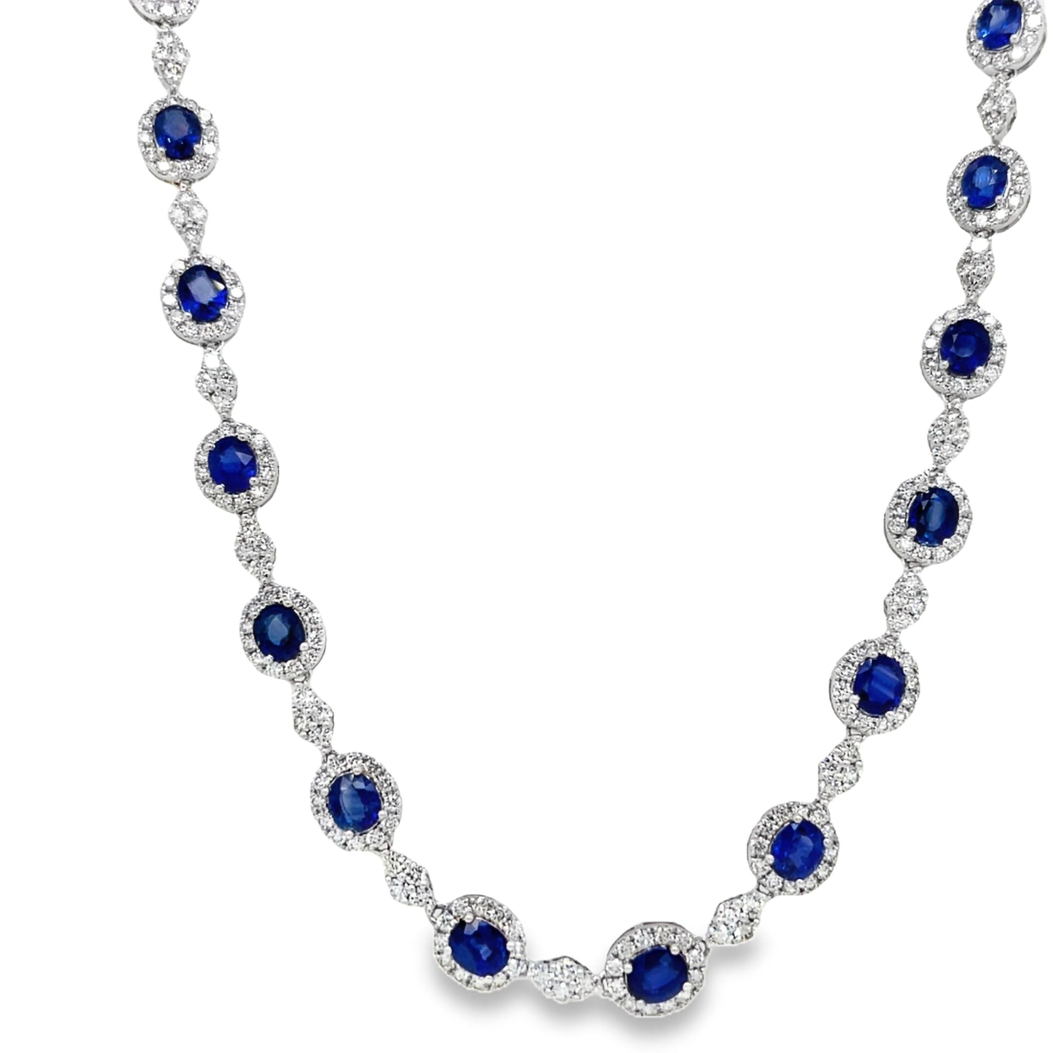 Indulge in luxury with our Blue Sapphire and Diamond Necklace. The 28 oval shape sapphires, totaling 14.67 carats, are complemented by 7.70 carats of round diamonds, set in 18k white gold. The hidden clasp ensures a seamless and elegant look, perfect for any occasion. Measuring 18", this necklace is a must-have for any sophisticated and exclusive wardrobe.