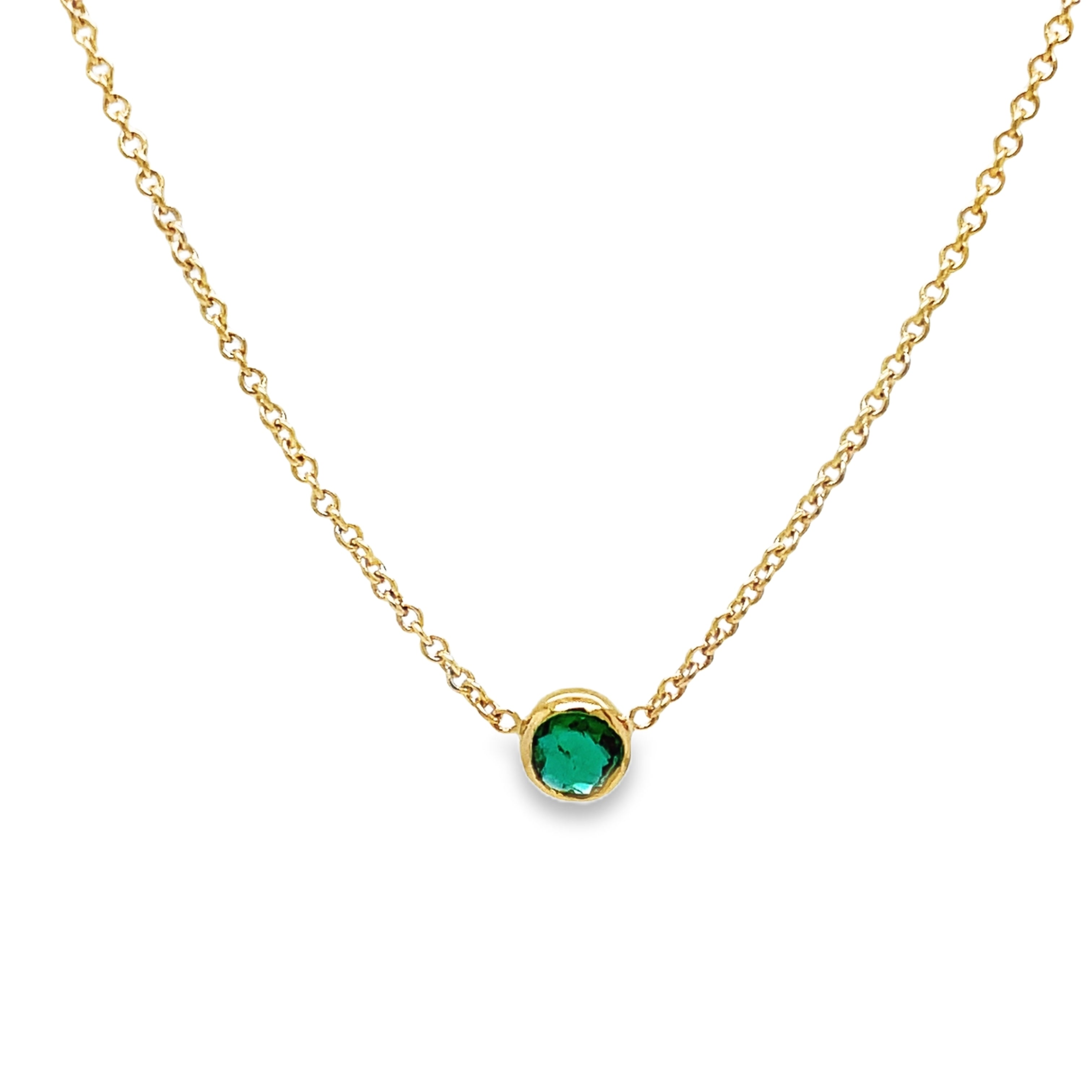 dulge in the exquisite elegance of our Small Colombian Round Emerald Necklace. The dainty 14k yellow gold chain delicately showcases a stunning round emerald, evoking luxury and sophistication. With a secure lobster clasp, this 16" necklace is the perfect choice for a touch of timeless beauty.