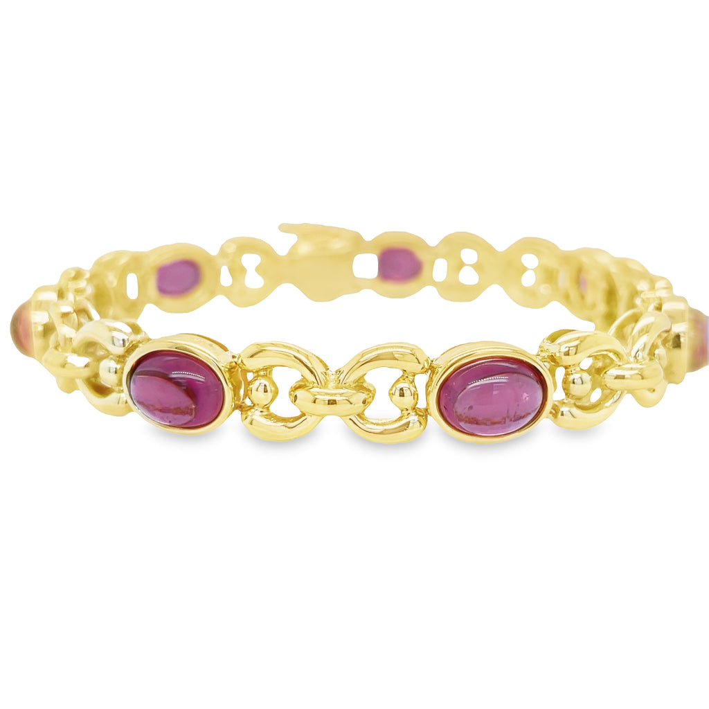 Make a statement with this dazzling Pink Tourmaline Yellow Gold Bracelet. Crafted from 18K yellow gold and seven oval cabochon pink tourmalines, this elegant and unique bracelet is perfect for any occasion. Enjoy the luxurious feel of solid gold and the subtle sparkle of pink tourmaline stones. Make a bold statement and show off your style with this timeless and lovely bracelet.