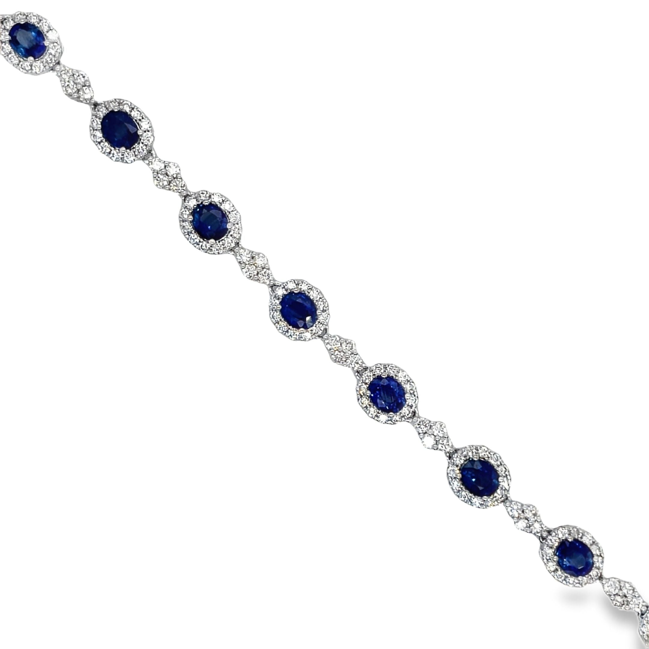 ndulge in luxury with our Blue Sapphire and Diamond Bracelet. The oval shape sapphires, totaling 5.97 carats, are complemented by 3.08 carats of round diamonds, set in 18k white gold. The hidden clasp ensures a seamless and elegant look, perfect for any occasion. Measuring 7.5", this bracelet is a must-have for any sophisticated and exclusive wardrobe.