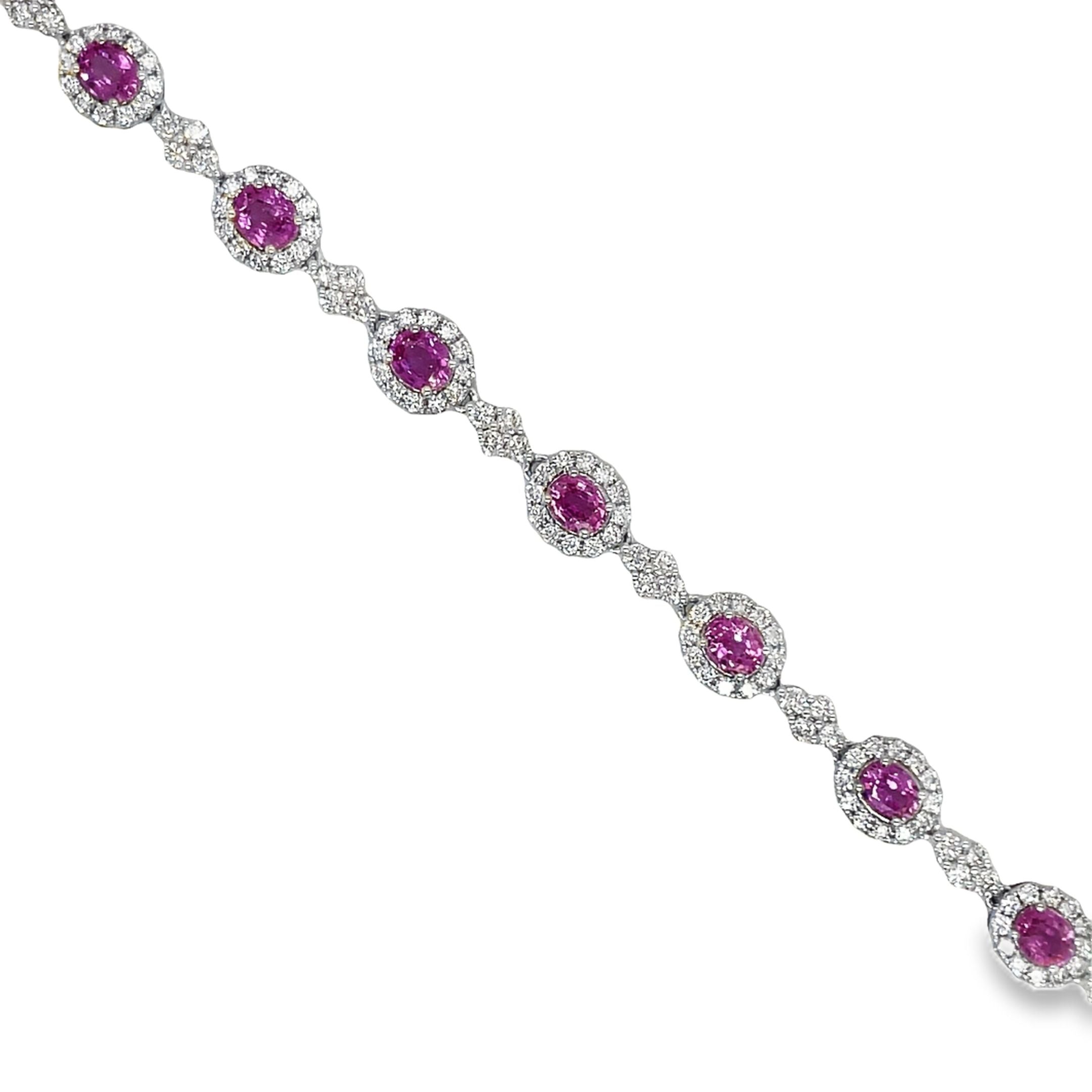 This exquisite bracelet features a 5.53 carat oval pink sapphire and 3.29 carats of dazzling round diamonds set in 18k white gold. With a sleek 7.5" length and hidden clasp, this luxurious piece is the epitome of elegance and sophistication. Add a touch of glamour to any outfit with this stunning Pink Sapphire &amp; Diamond Bracelet.