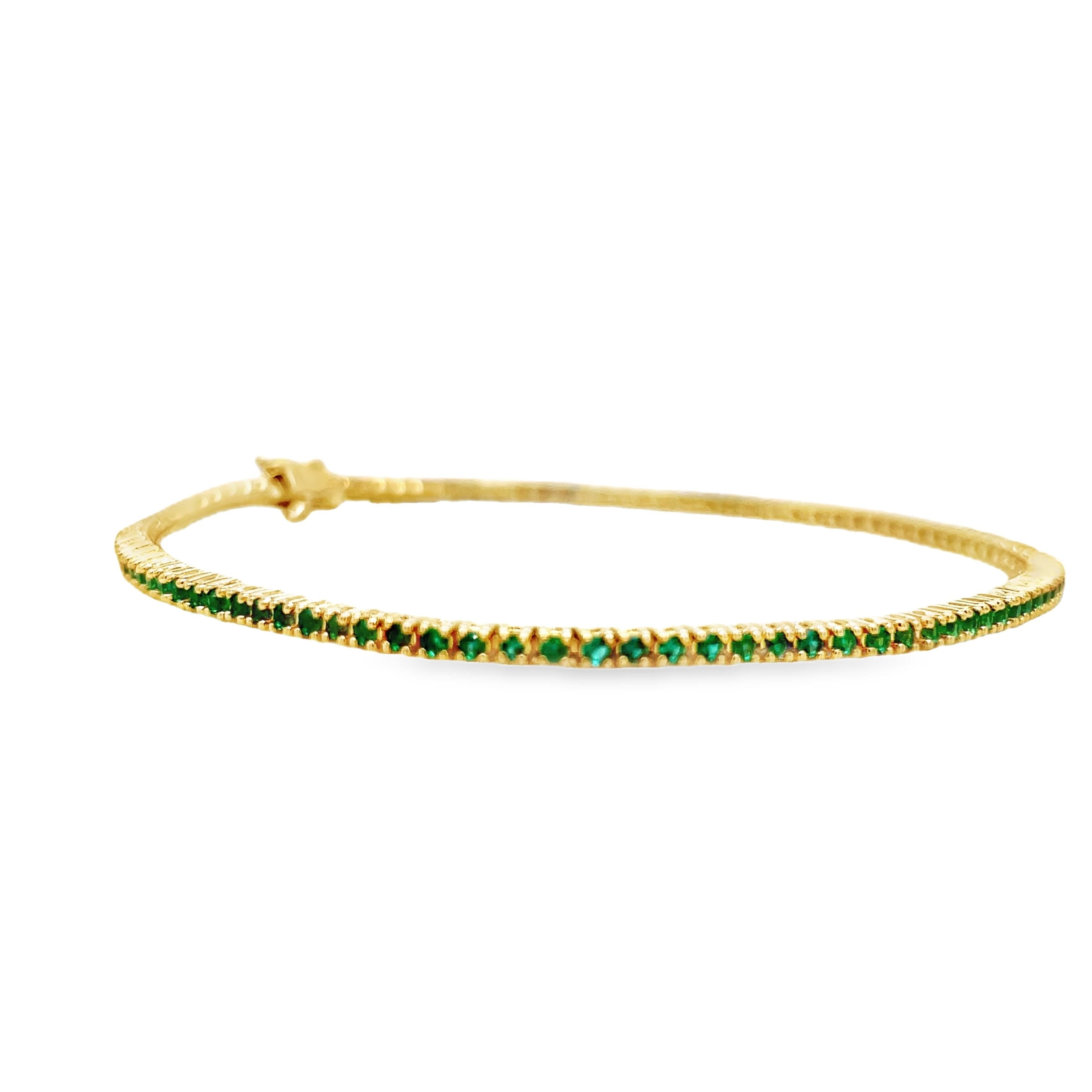 ndulge in luxury with our 18k Italian Made Emerald Line Tennis Yellow Gold Bracelet. Handcrafted in Italy, this exquisite piece features 1.00 cts of round emeralds with good color. The secure clasp ensures peace of mind, making it a must-have for your jewelry collection. Elevate your style with this exclusive line bracelet.