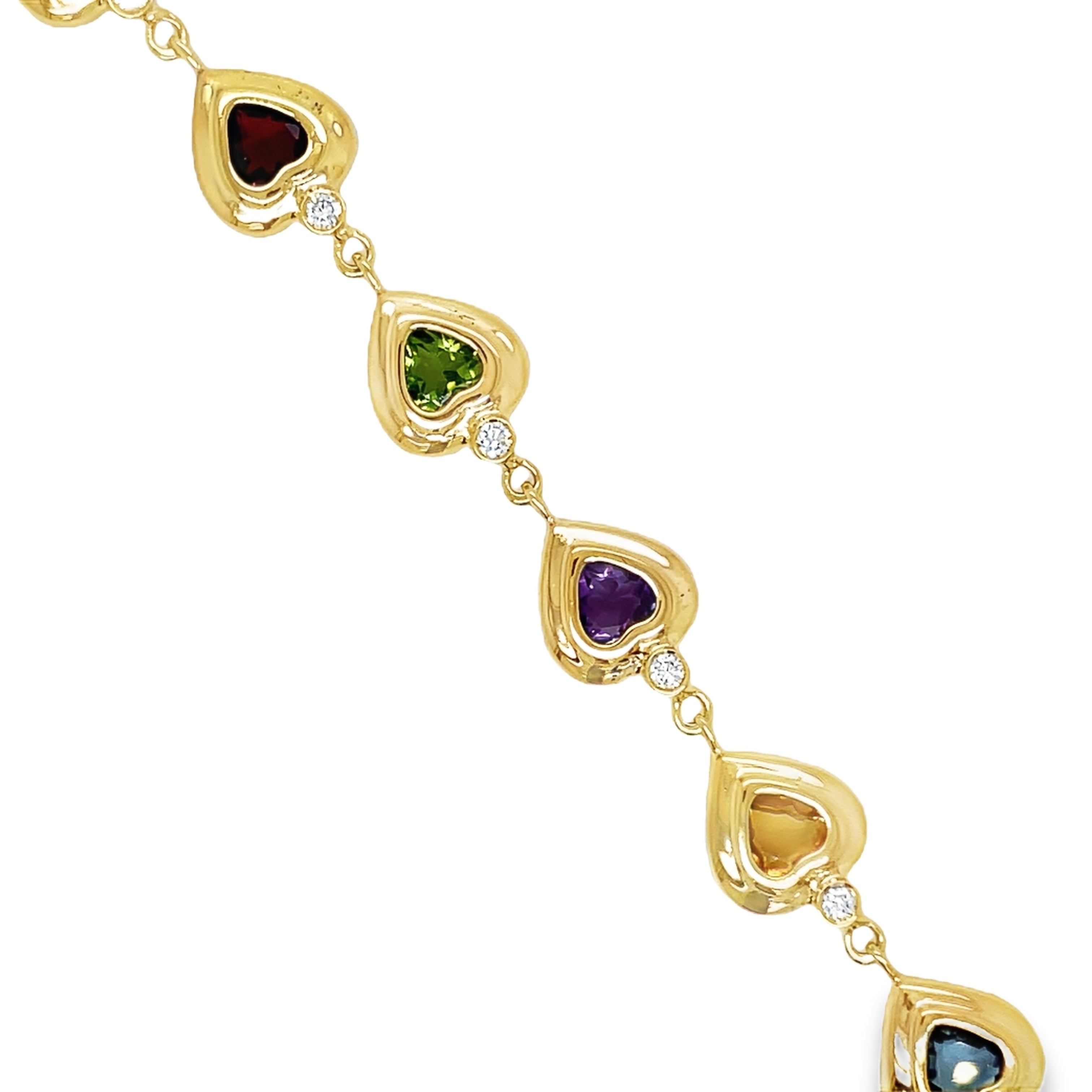 ndulge in luxury with our Multicolor Gem Heart Shape Yellow Gold Bracelet. Crafted with 14k yellow gold, this bracelet features stunning amethyst, peridot, citrine, blue topaz, and diamonds. The secure clasp ensures a perfect fit, making it the perfect accessory for any occasion. Measures 6.5" long.