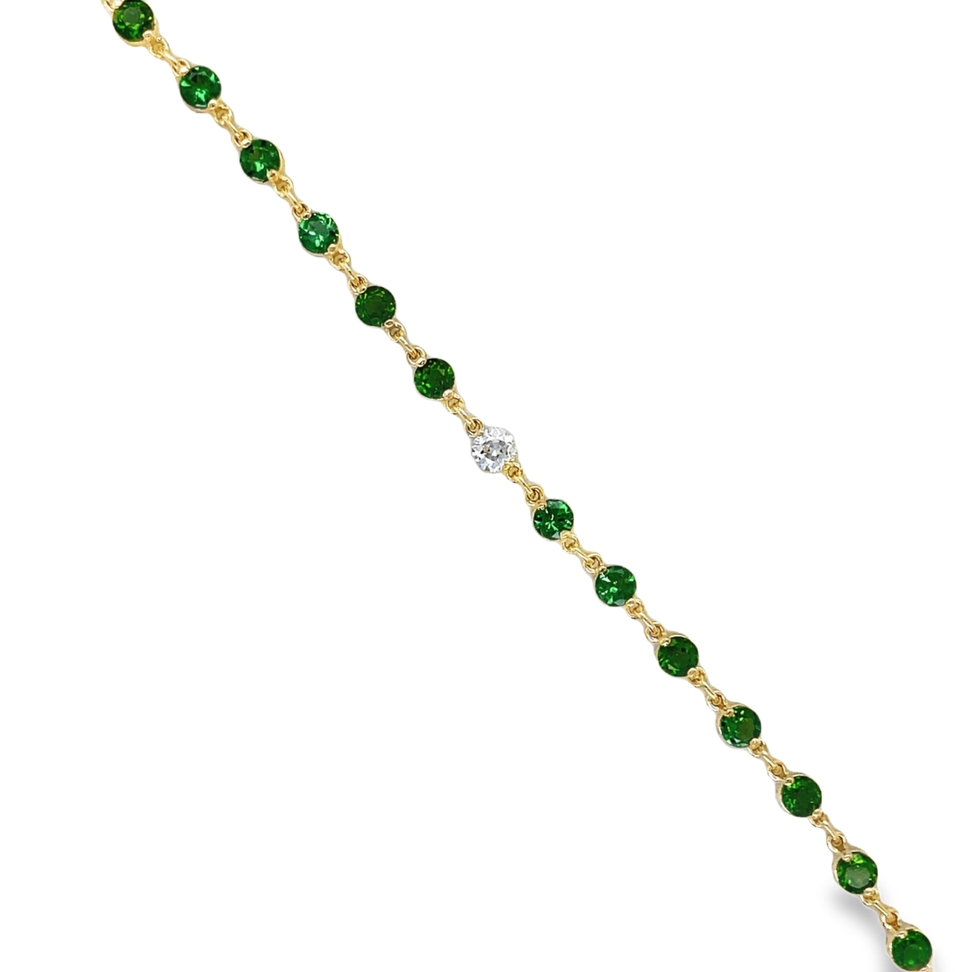 ndulge in the opulence of our Tsavorite &amp; Diamond Bezel Bracelet. Crafted from 14k yellow gold, it boasts 16 round tsavorite gems and two round diamonds, each individually bezel set for maximum elegance. Elevate any outfit with this luxurious piece, a must-have for any modern-day sophisticate.